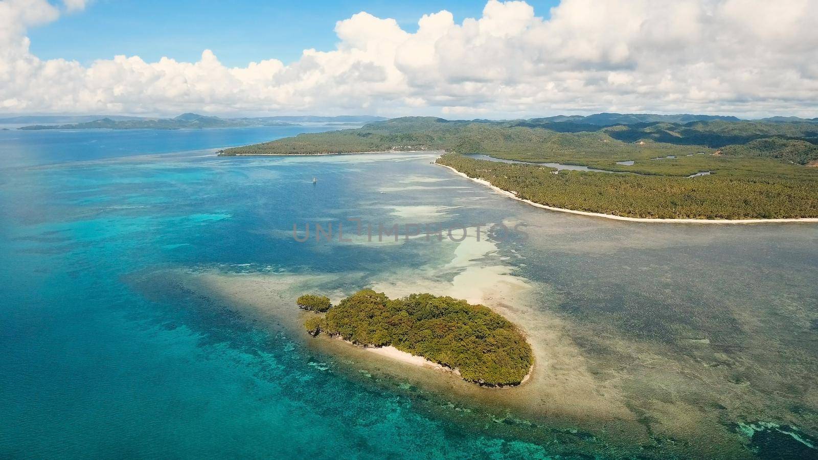 Aerial view of beautiful tropical island with sand beach, azure water. Seascape:Tropical lagoon with turquoise water. Beautiful tropical beach on the island. Philippines. Travel concept.
