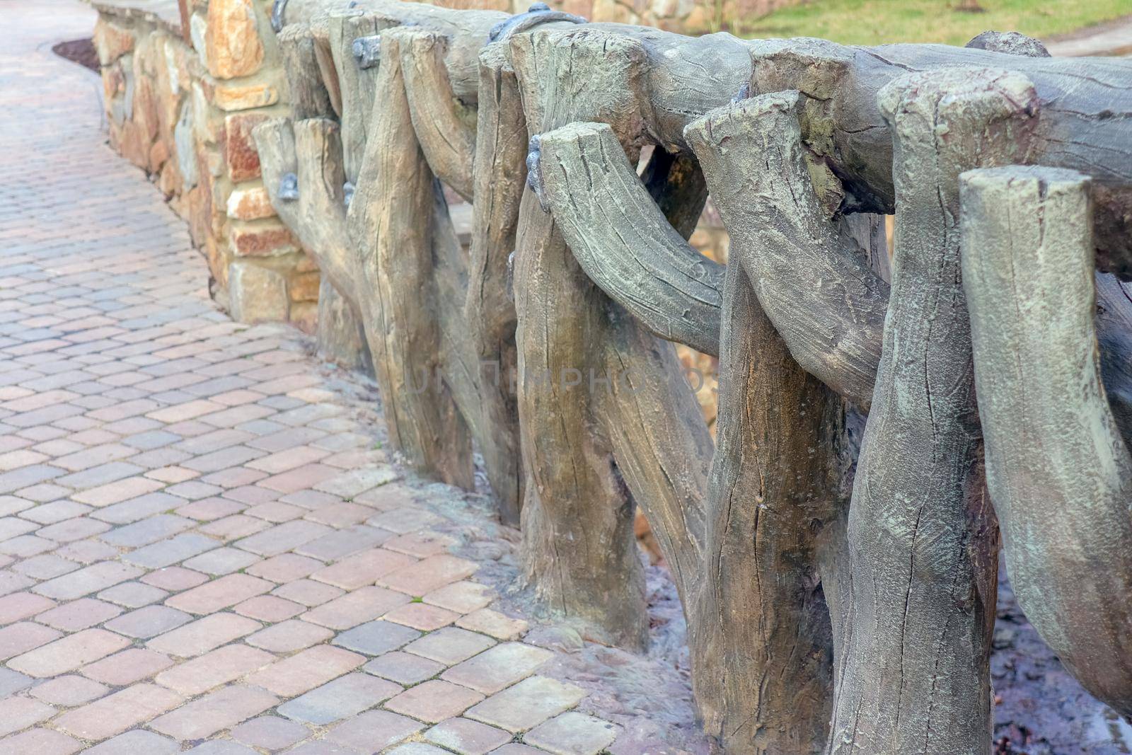 sidewalk fence made of tree branches as background by roman112007