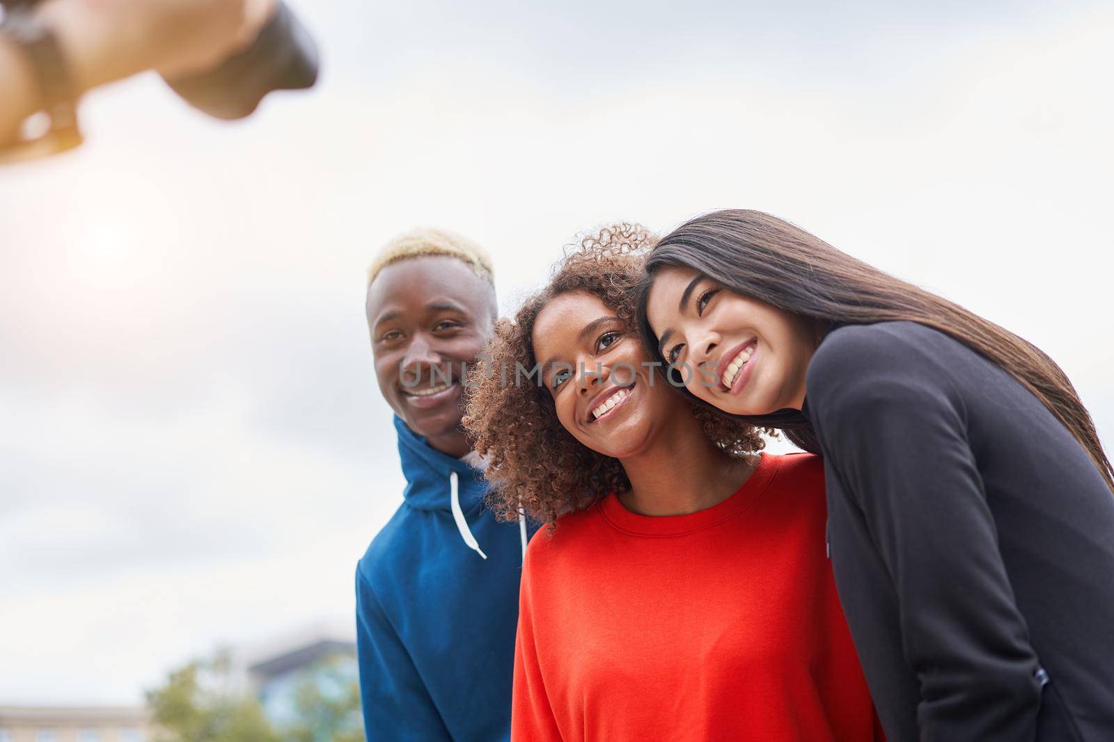 Multi ethnic friends outdoor on photo shooting looking at camera. Diverse group people Afro american asian spending time together Multiracial male female student meeting outdoors for photo