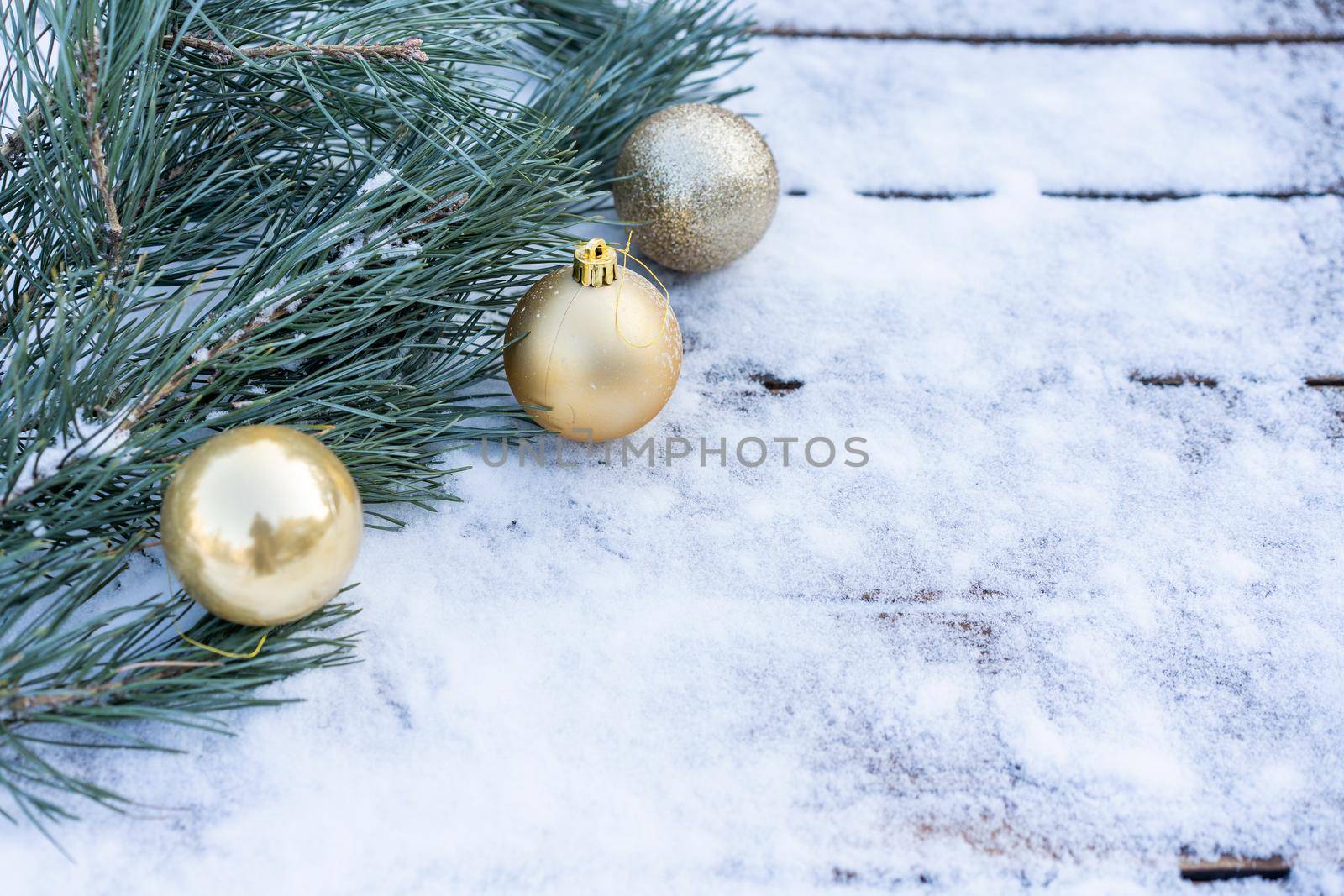 Winter background. Empty wooden plank with snowy border with pine branch and christmas ball decoration, copy space for text Wood table to. For product display Christmas time mock up