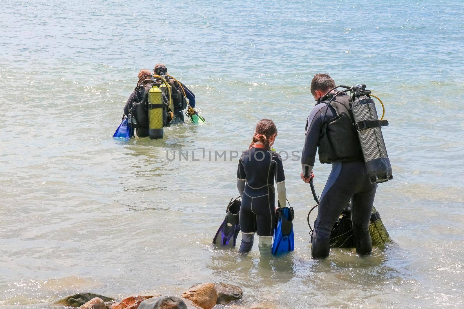 divers enter the water on the beach. High quality photo