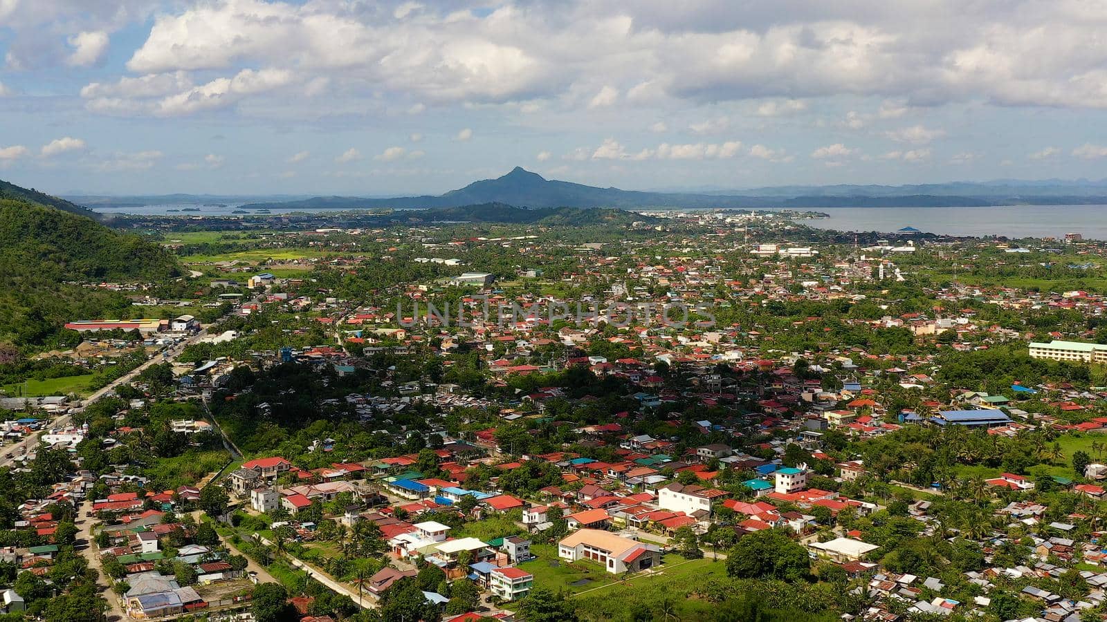 Tropical landscape with panorama of Tacloban, aerial view. Town and sky with cumulus clouds. Leyte Island, Philippines. . Summer and travel vacation concept.