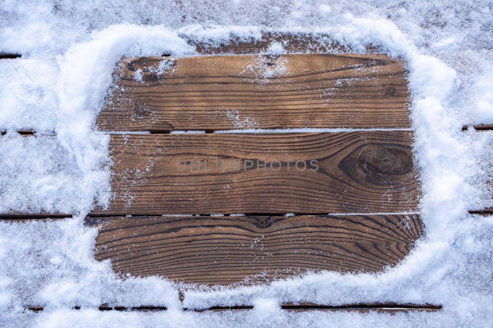 Winter background. Empty wooden plank with snowy border, copy space for text Wood table to. For product display Christmas time mock up