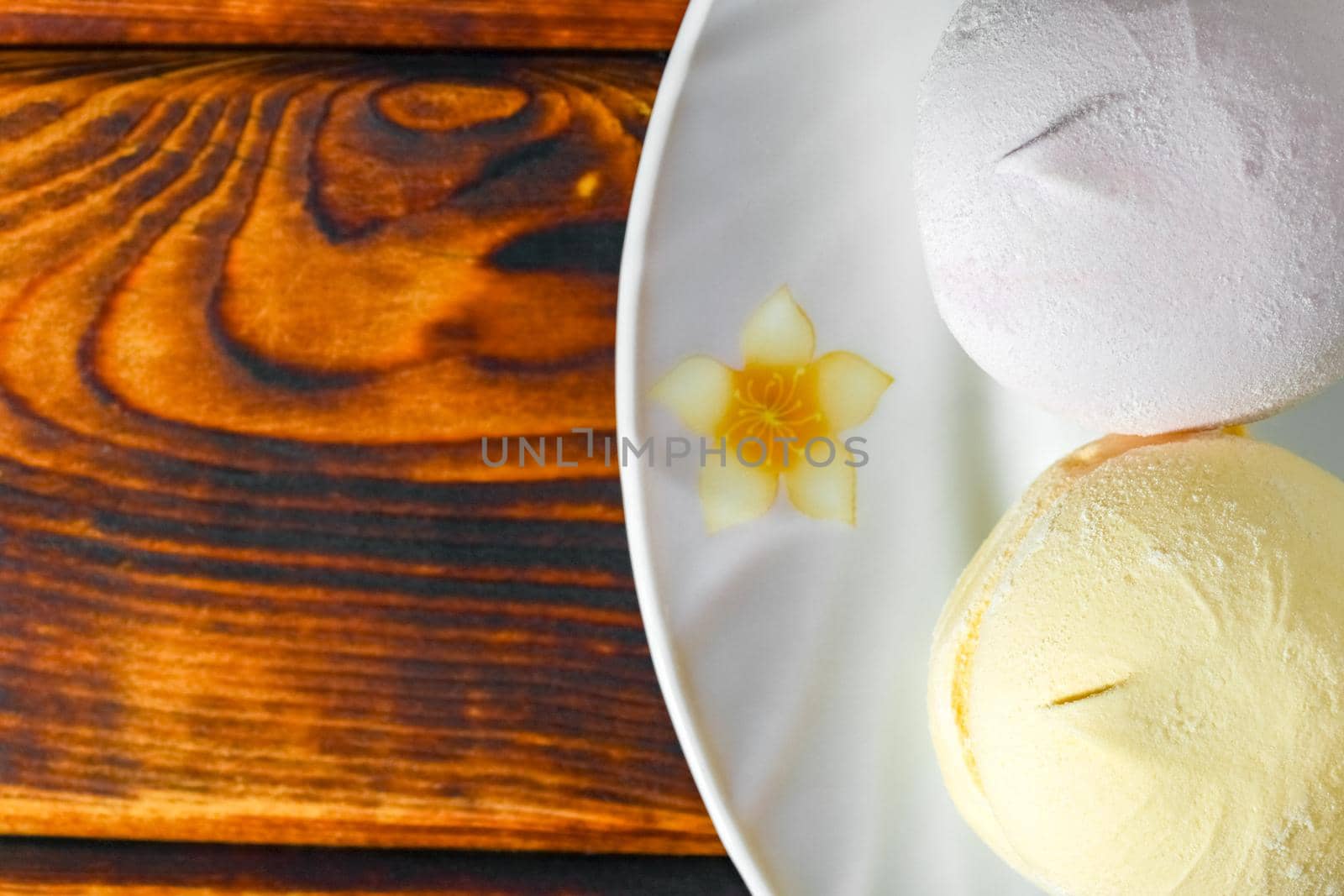 colorful marshmallows on a plate on a wooden background by roman112007