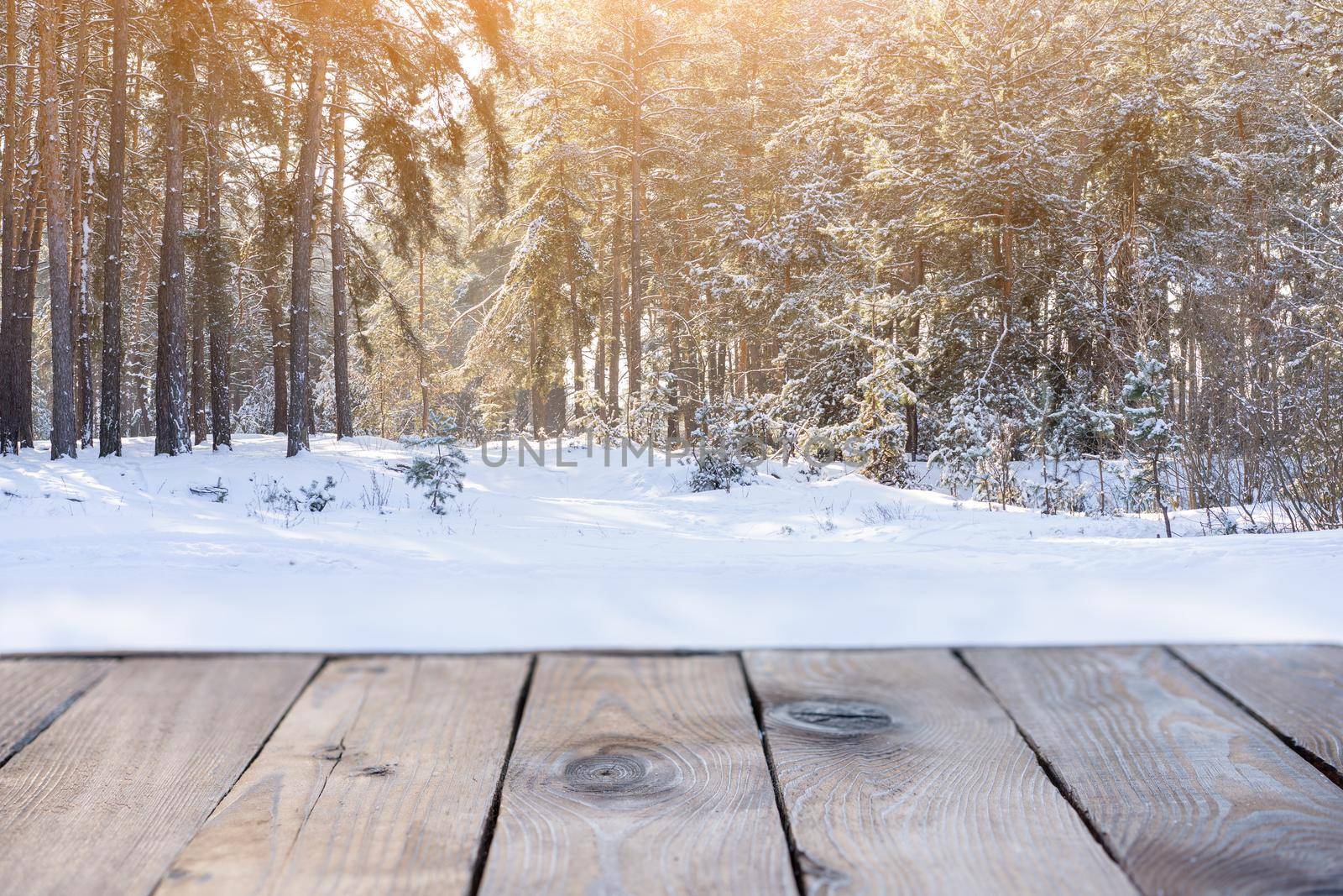 Beautiful winter scene. blurred background of snowy christmas nature background, Wood table top on shiny bokeh. For product display Christmas time mock up