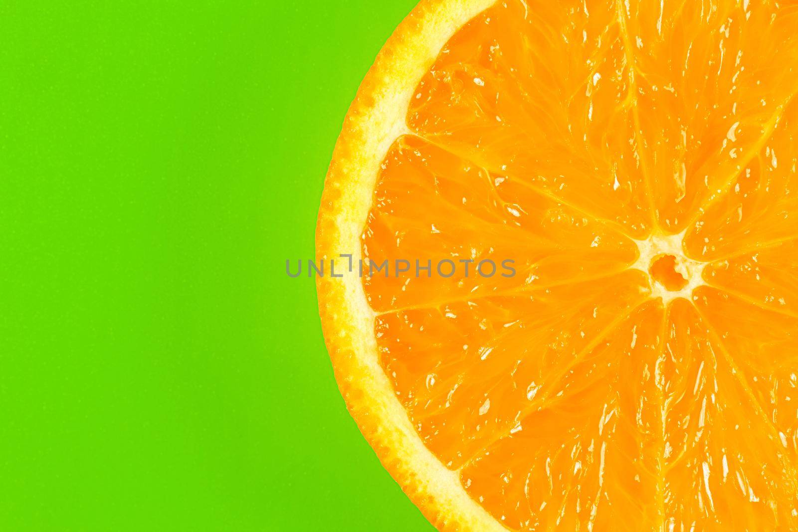 orange slice on a green background macro. place for the label. High quality photo