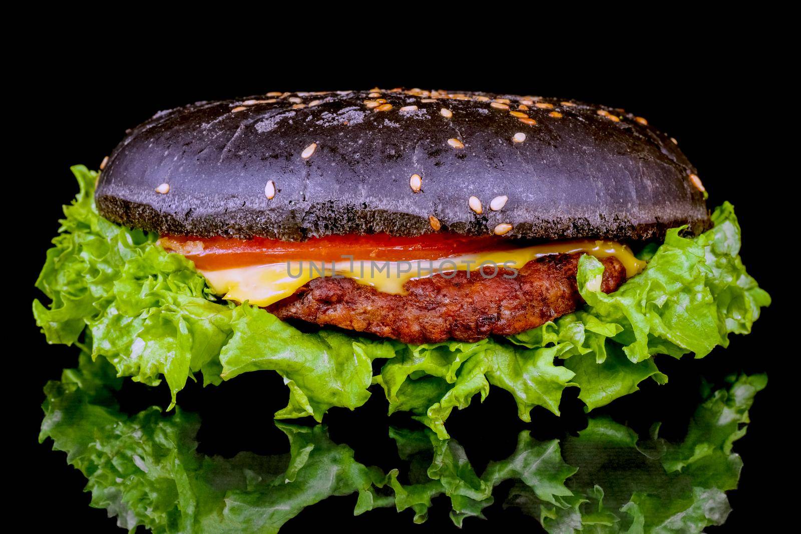 black hamburger close up on a black background . High quality photo