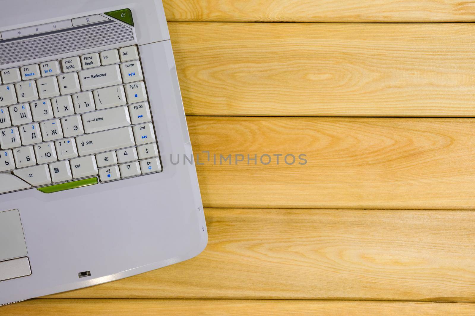 laptop on a wooden background top view by roman112007