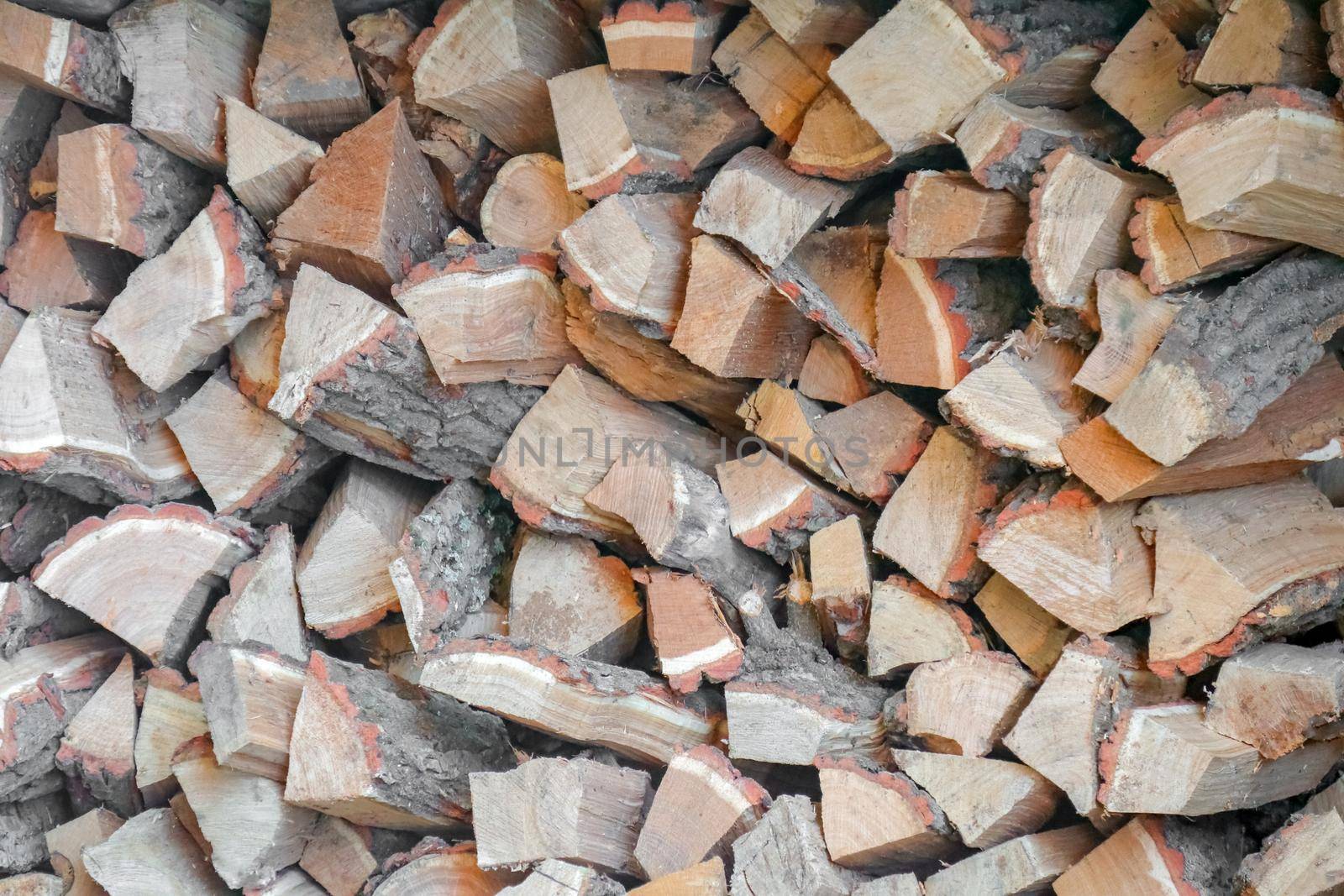 firewood chopped stacked in several layers macro. High quality photo