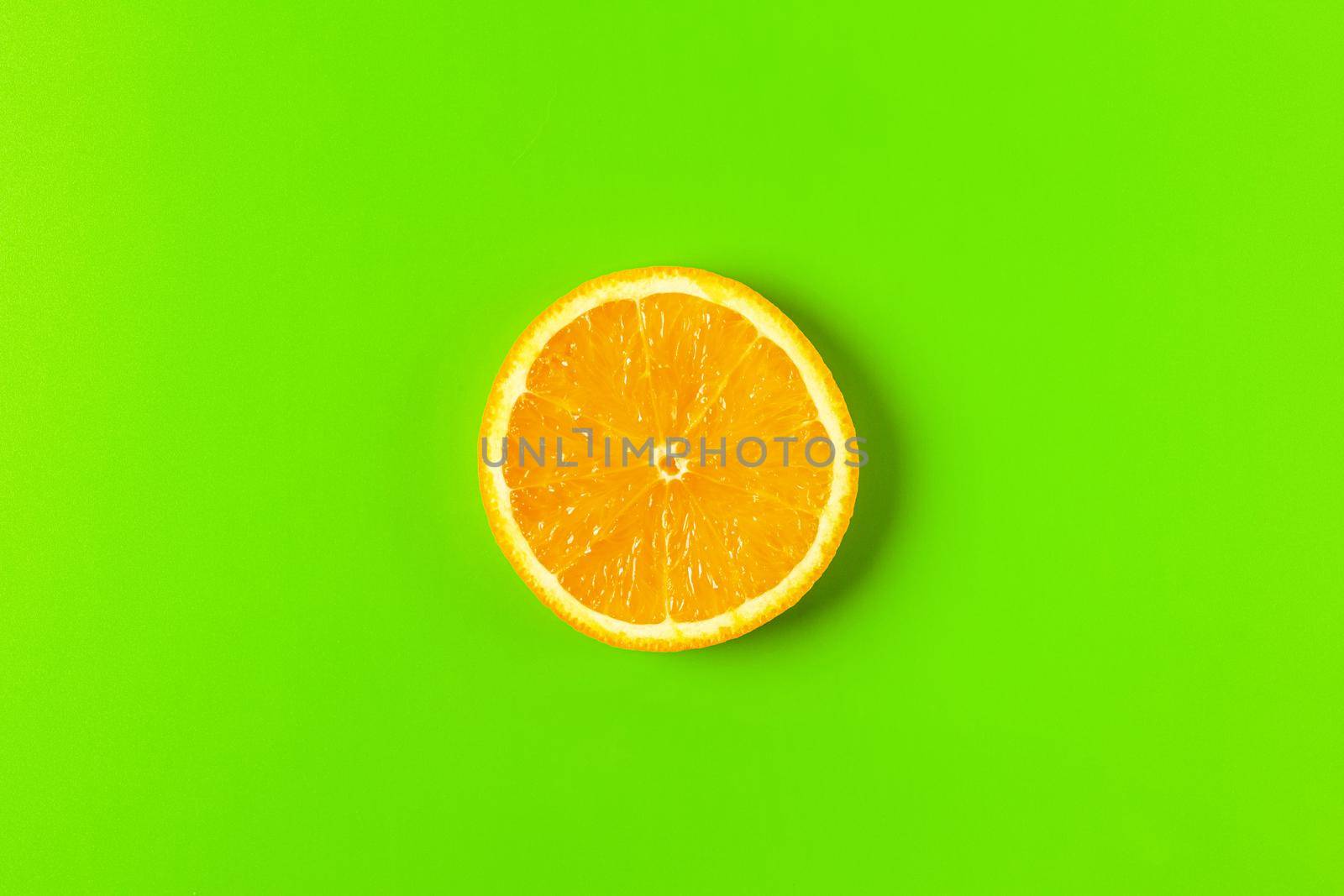 orange slice on a green background macro. place for the label by roman112007