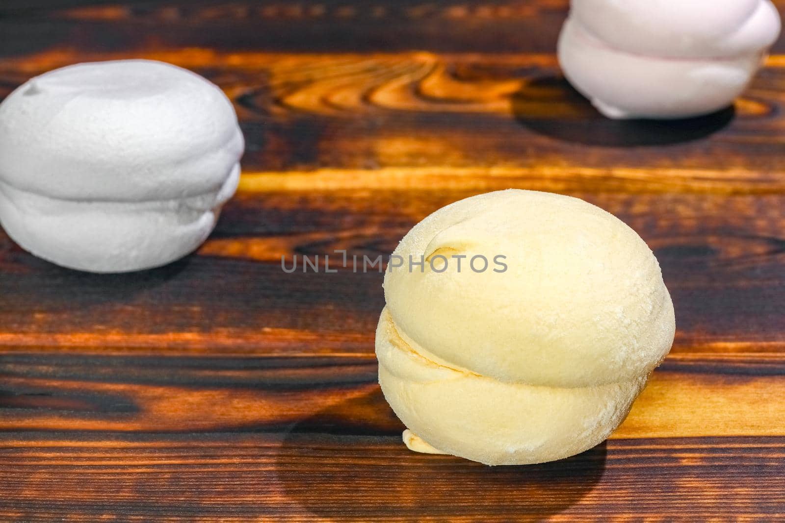 multicolored marshmallow on a wooden background macro by roman112007