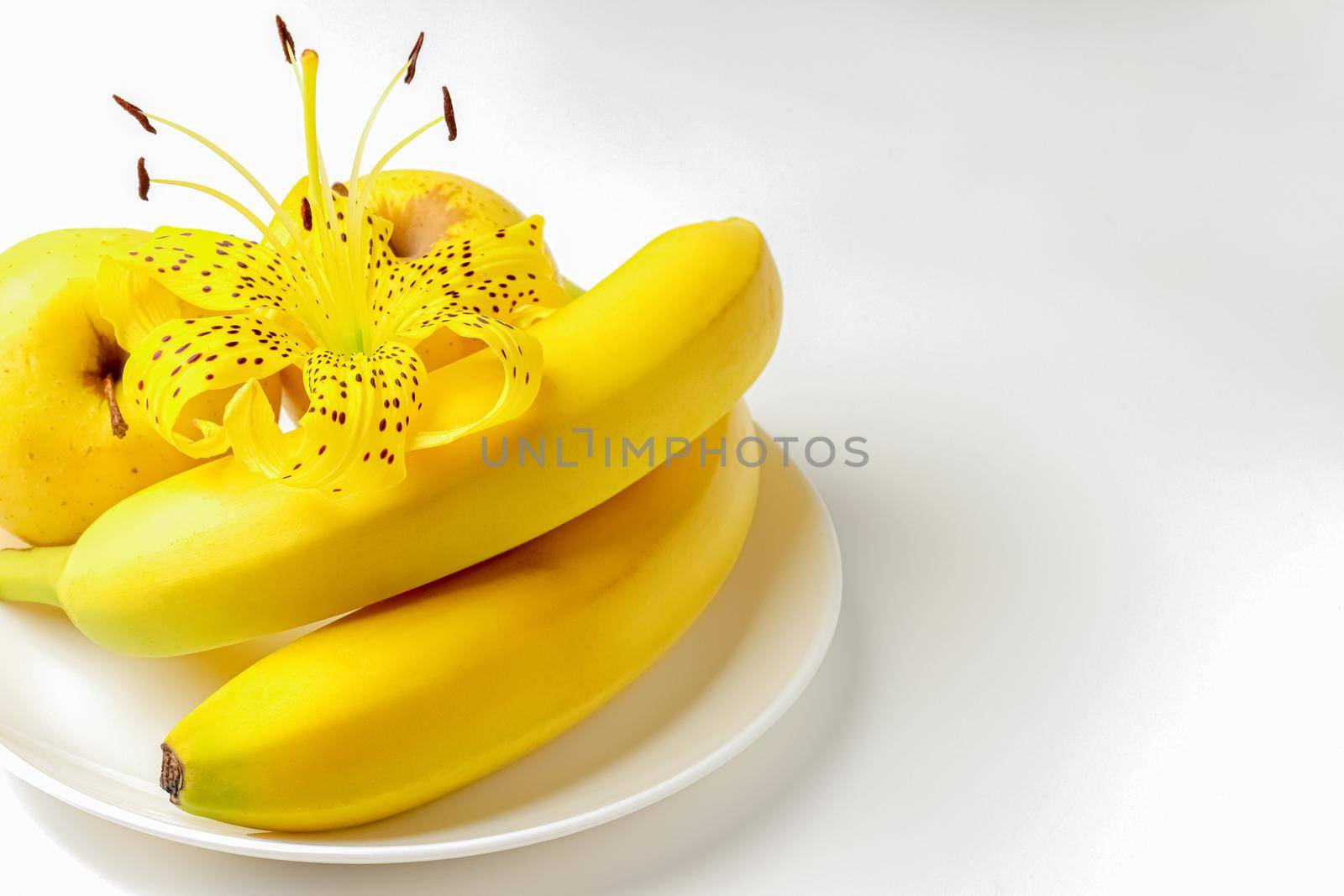 tiger Lily with banana and Apple on a white background close-up. isolate by roman112007