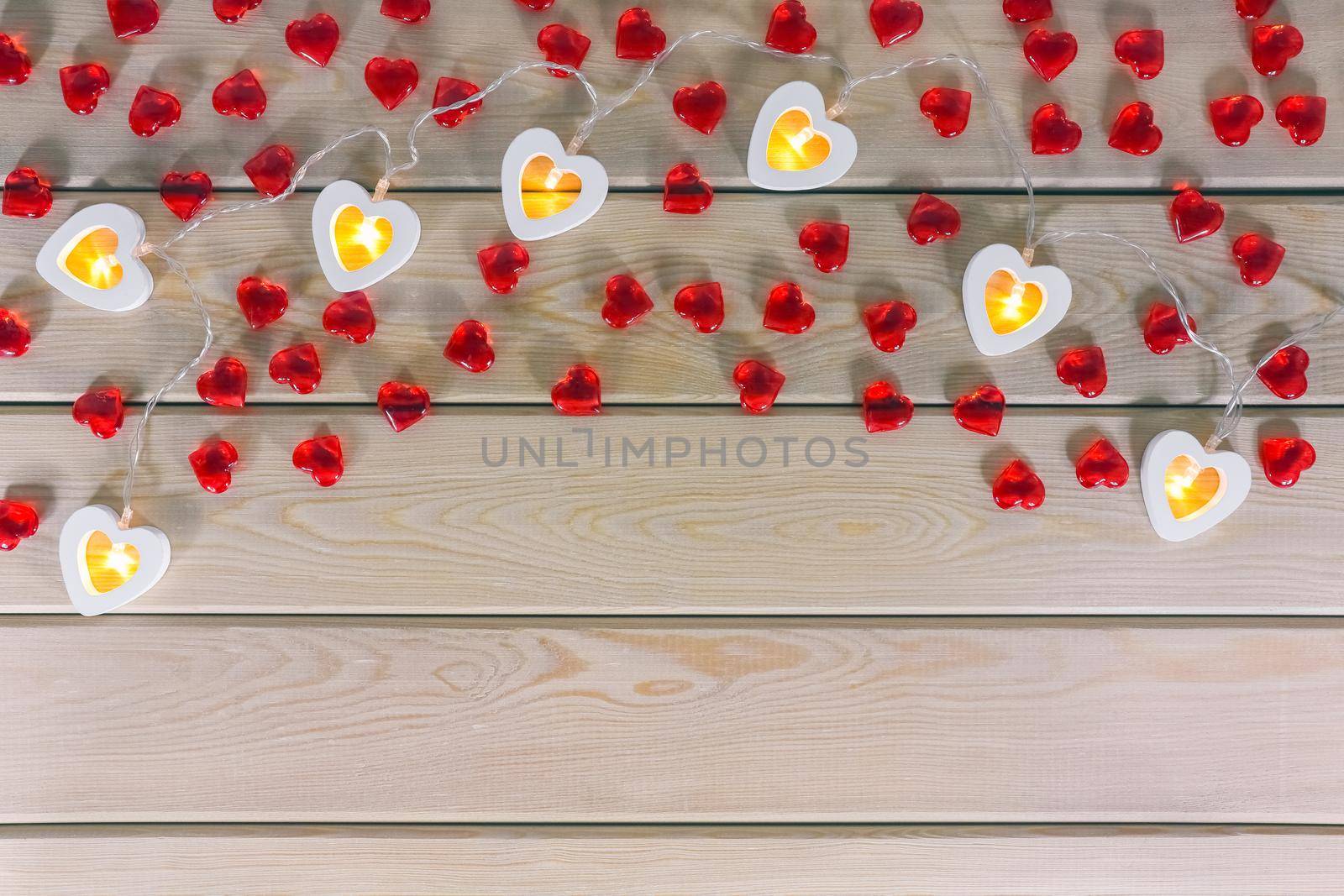 hearts garland on a wooden background top view  by roman112007