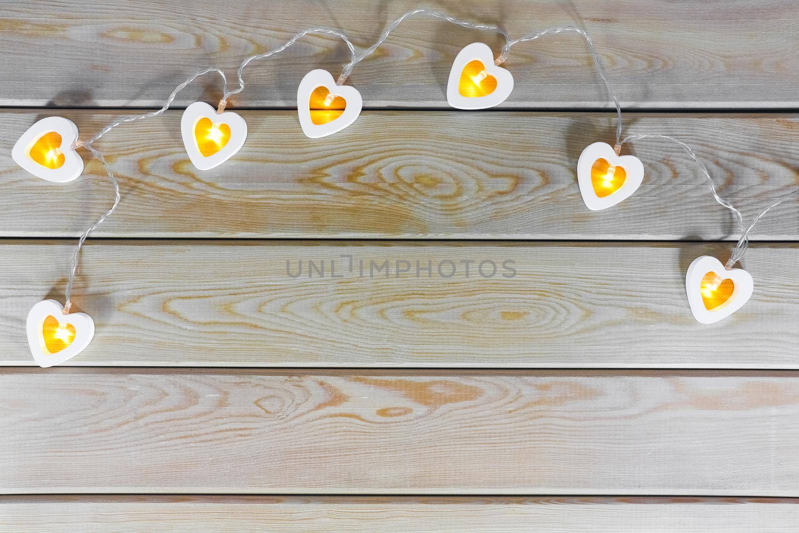 hearts garland on a wooden background top view  by roman112007