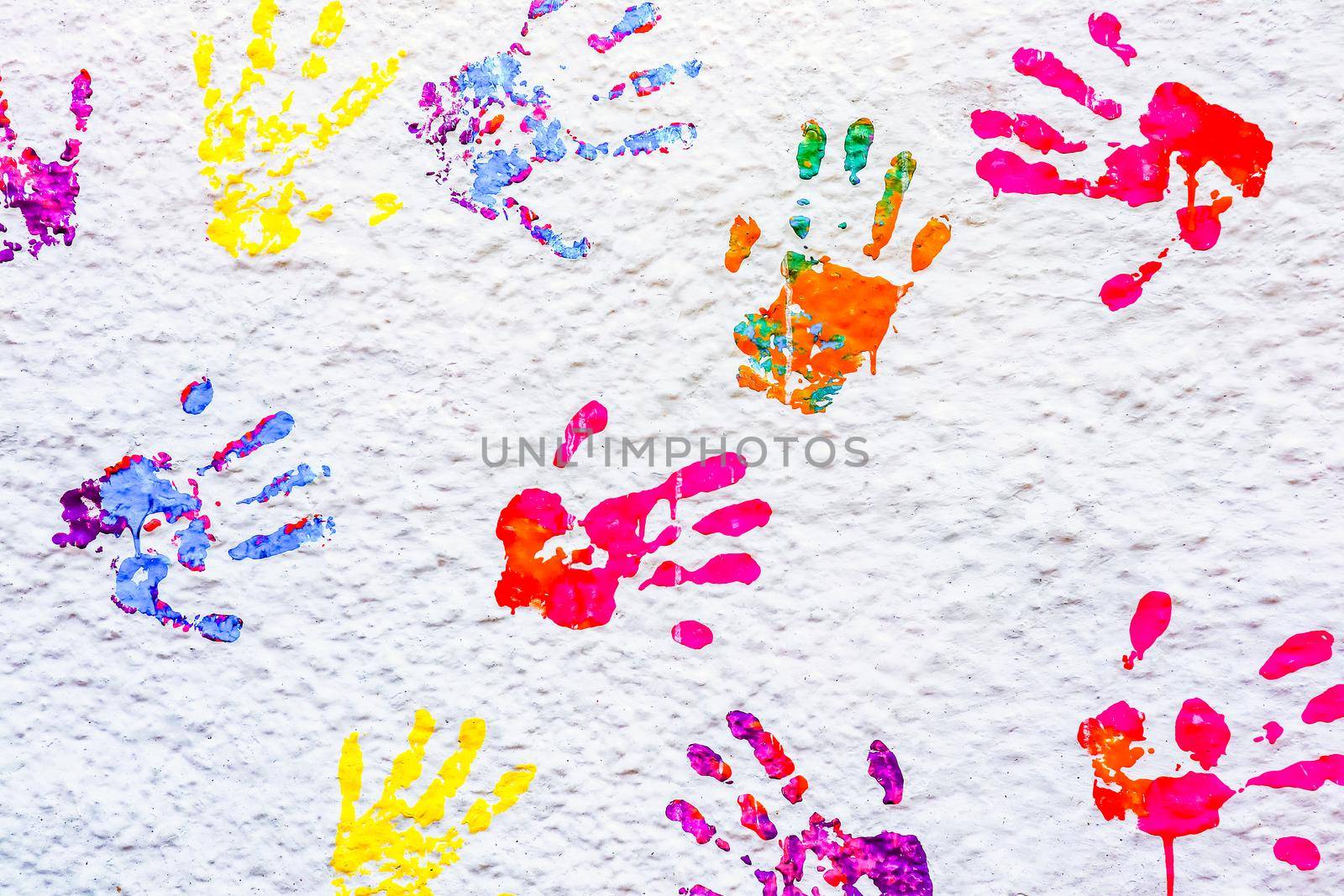 handprints paint on a white wall. High quality photo