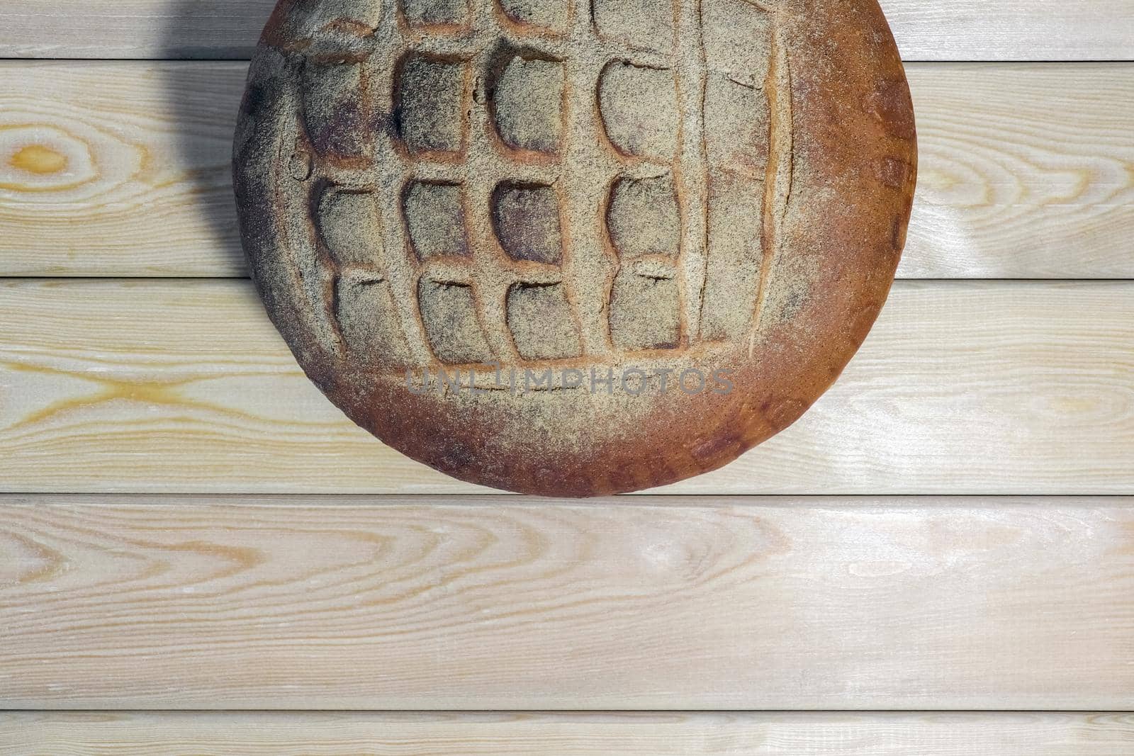 a loaf of bread on a wooden background. High quality photo