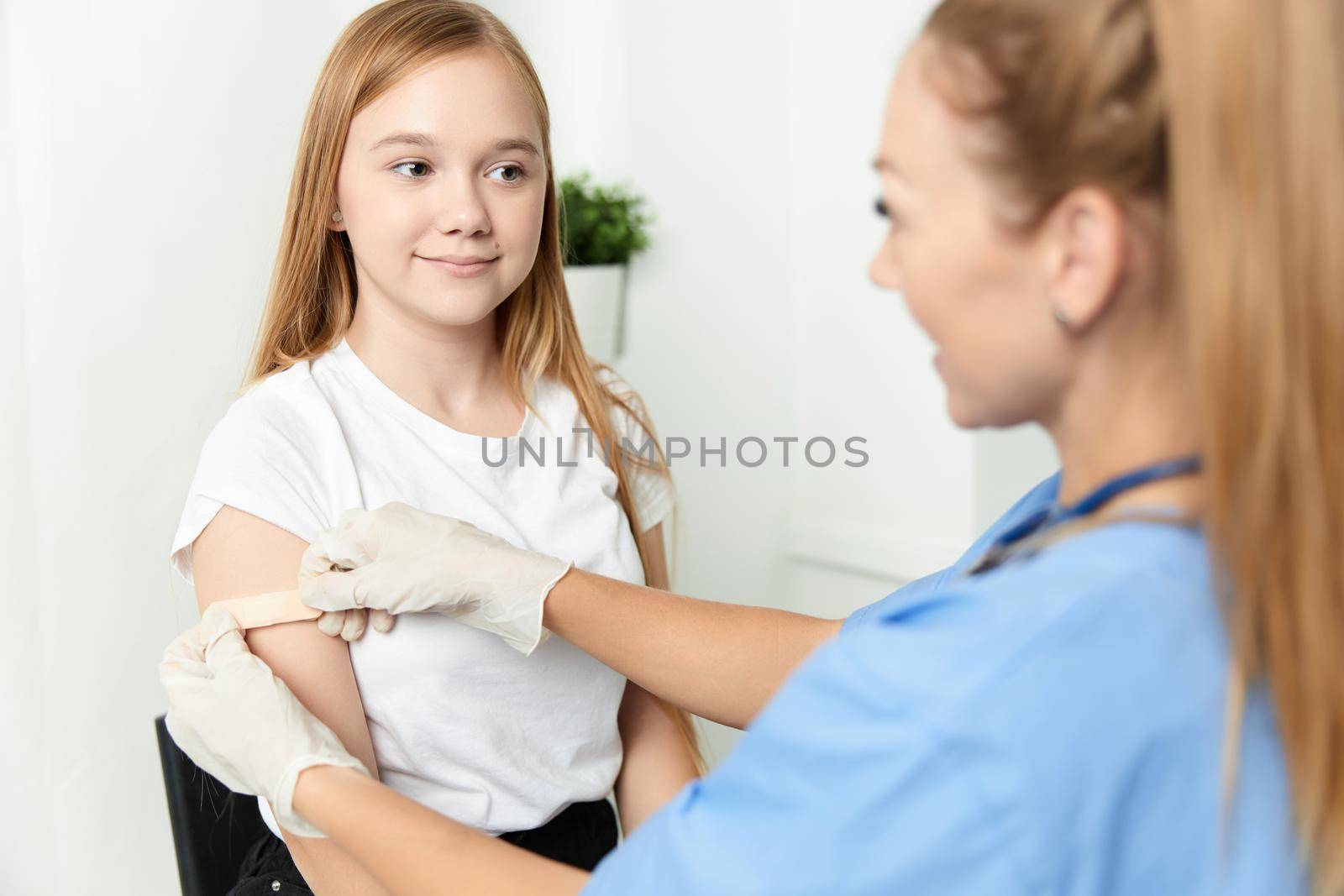 doctor tapes hand with adhesive tape vaccination hospital by SHOTPRIME