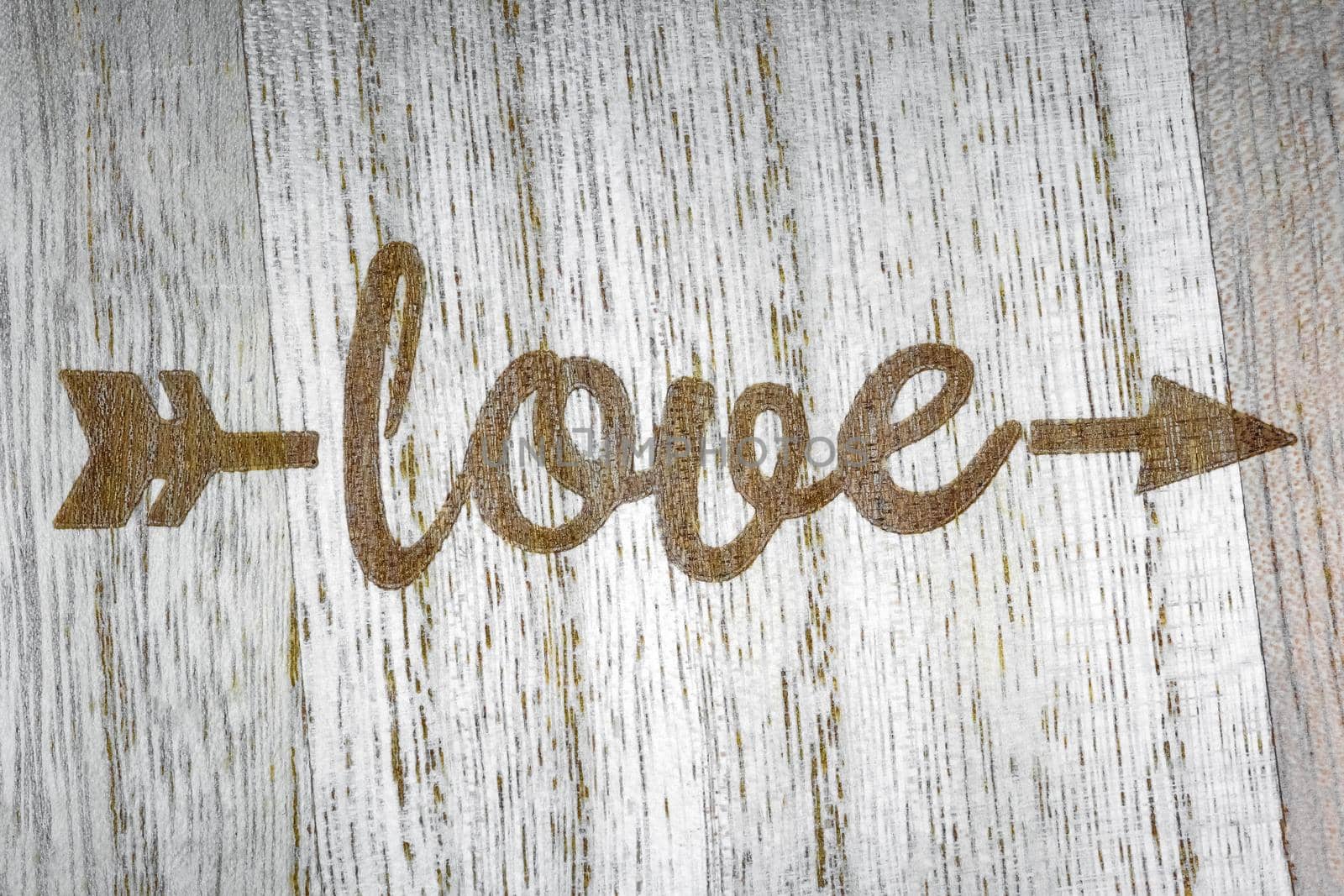 the inscription love on a wooden background top view. High quality photo