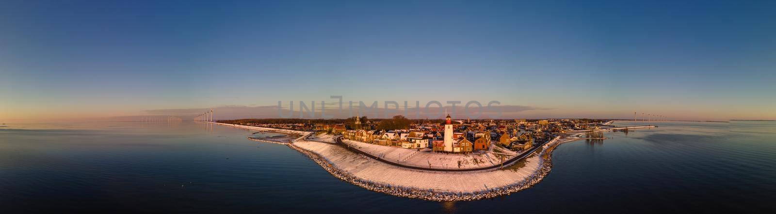 Panoramic view at the lighthouse of Urk Flevoland Netherlands, Urk during winter with white snow covered the beach. Winter in the Netherlands