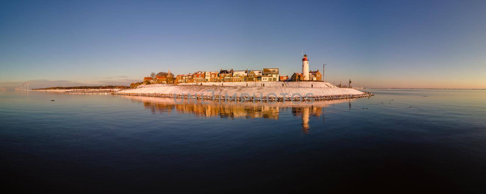 Panoramic view at the lighthouse of Urk Flevoland Netherlands, Urk during winter with white snow covered the beach by fokkebok