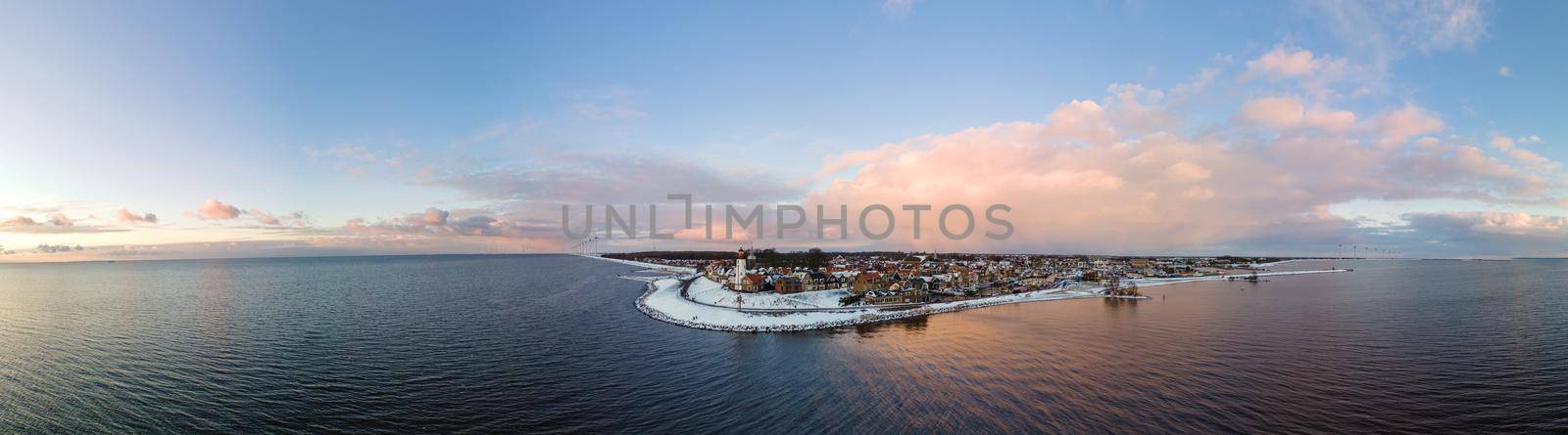 Panoramic view at the lighthouse of Urk Flevoland Netherlands, Urk during winter with white snow covered the beach by fokkebok