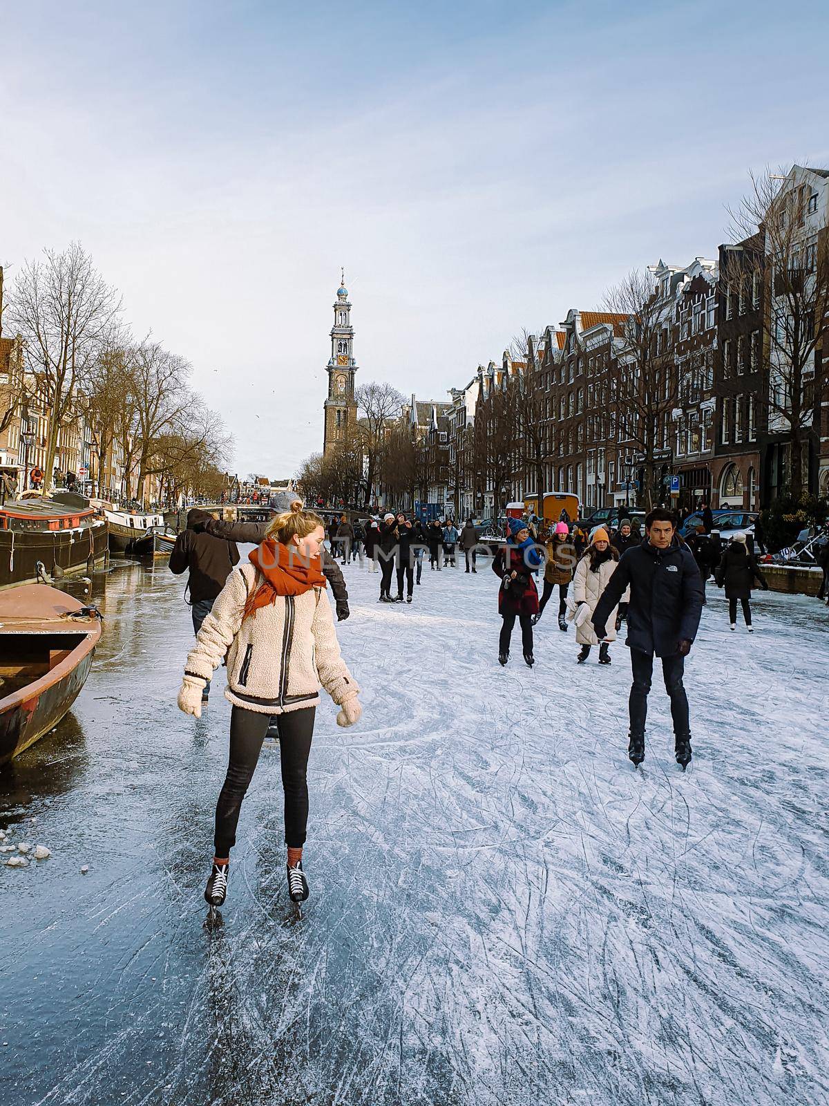 Amsterdam Netherlands, frozen canals and people ice skating in Amsterdam Netherlands february 2021