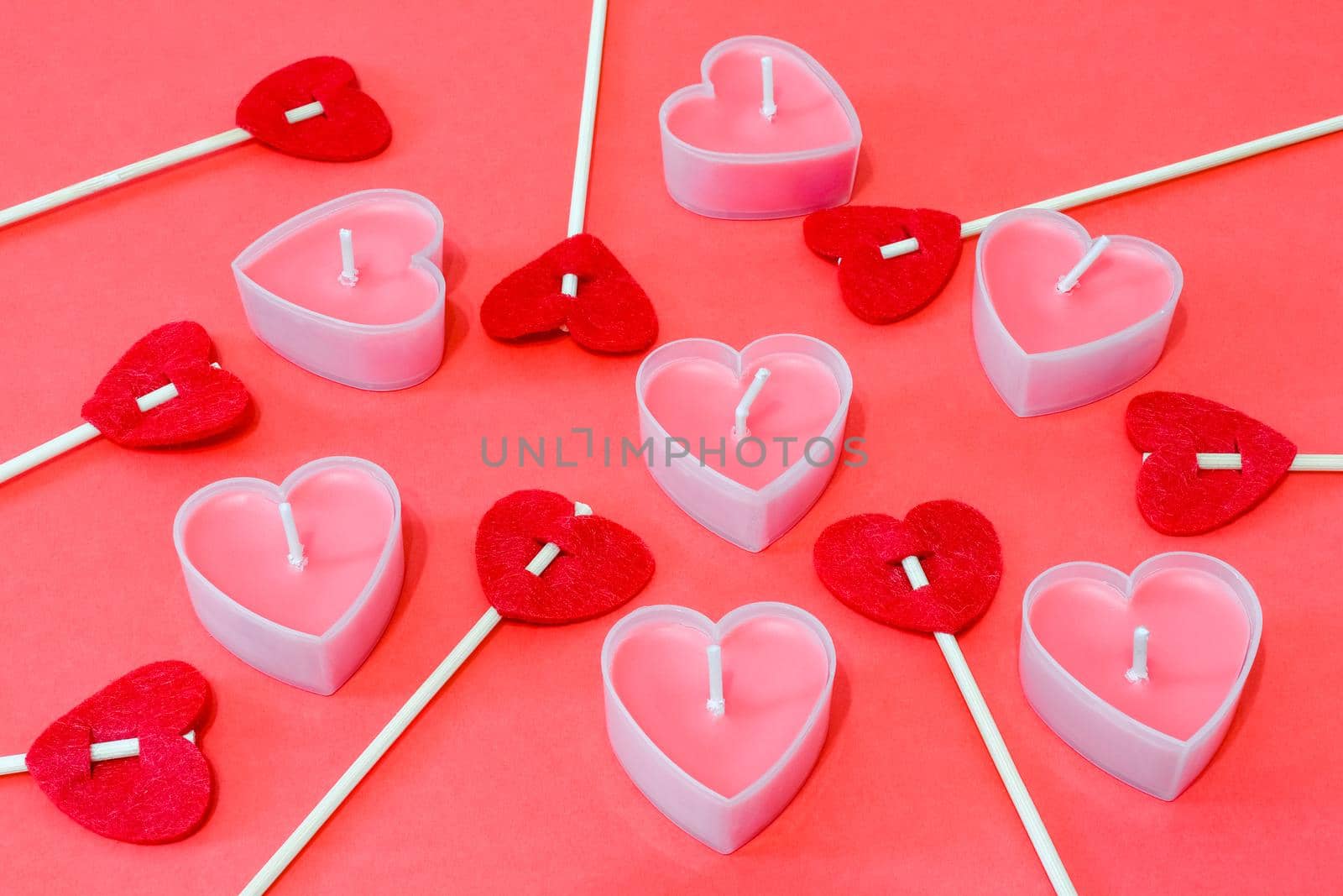 pink candles in the form of a heart on a red background for Valentine's day  by roman112007