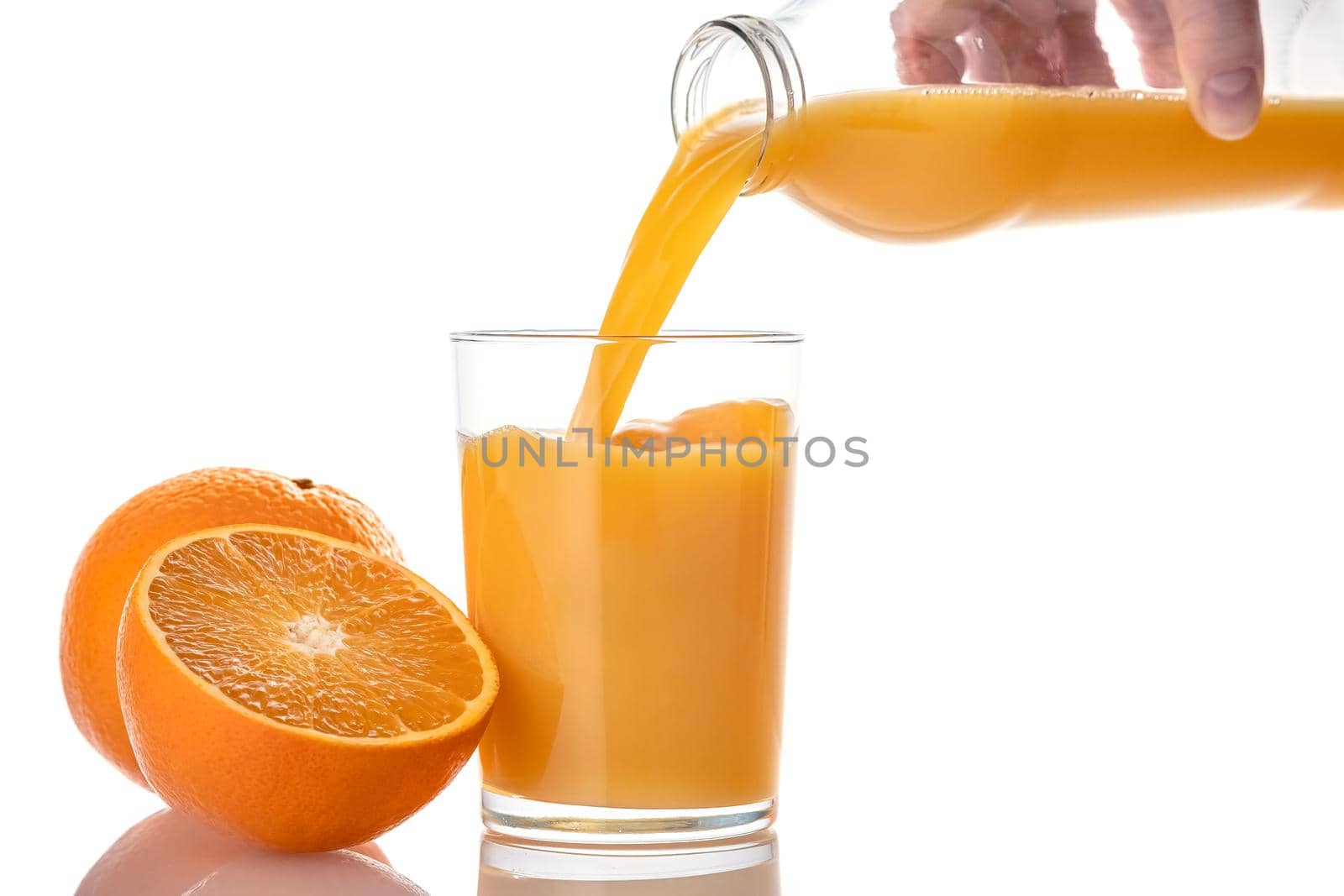 Woman Pouring Orange Juice in Glass, isolated on white background.