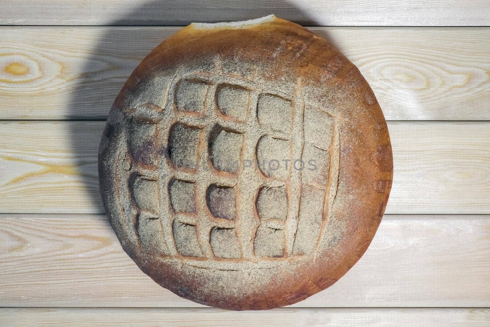 a loaf of bread on a wooden background. High quality photo