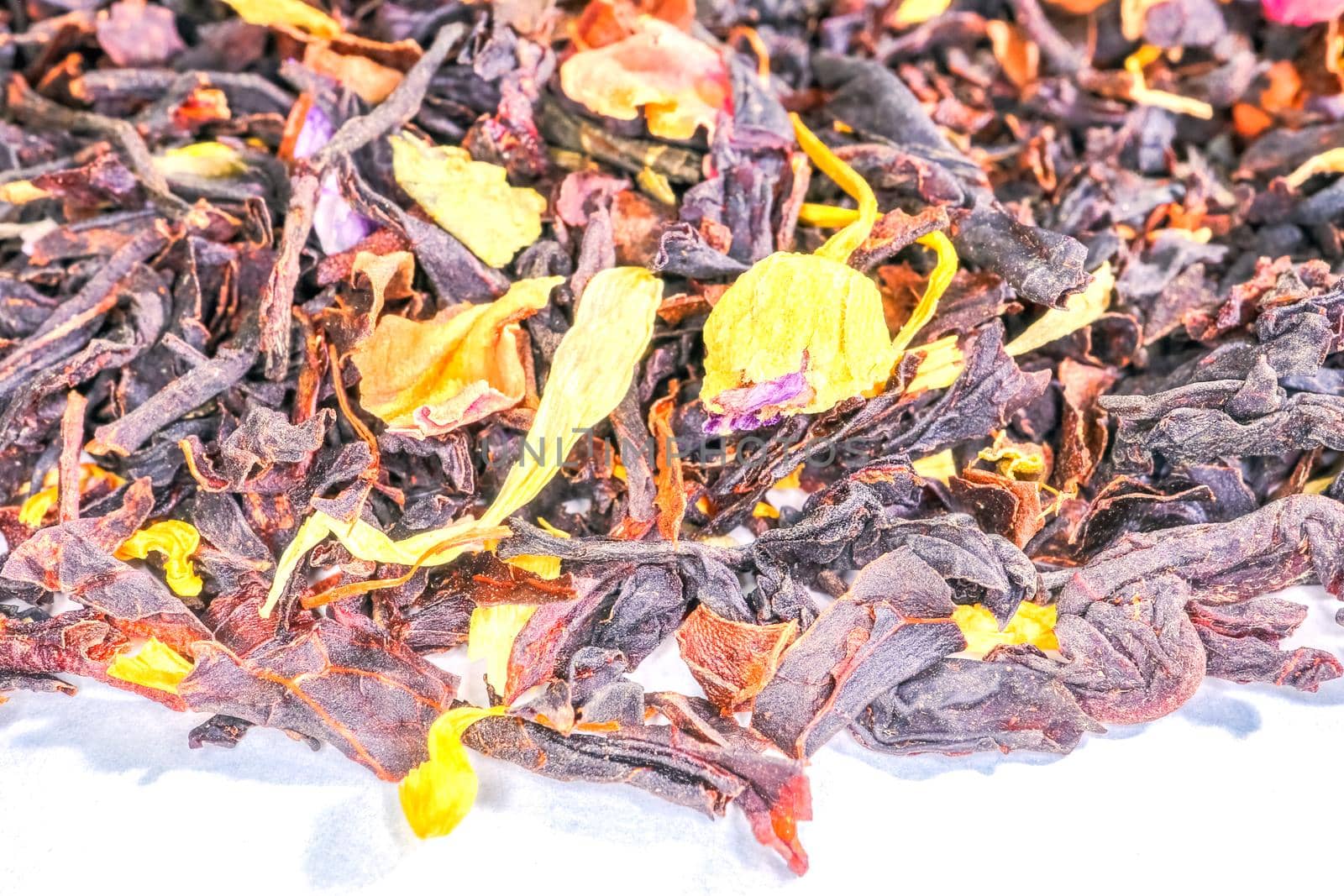  black tea with fruit pieces and flower petals macro isolate. High quality photo