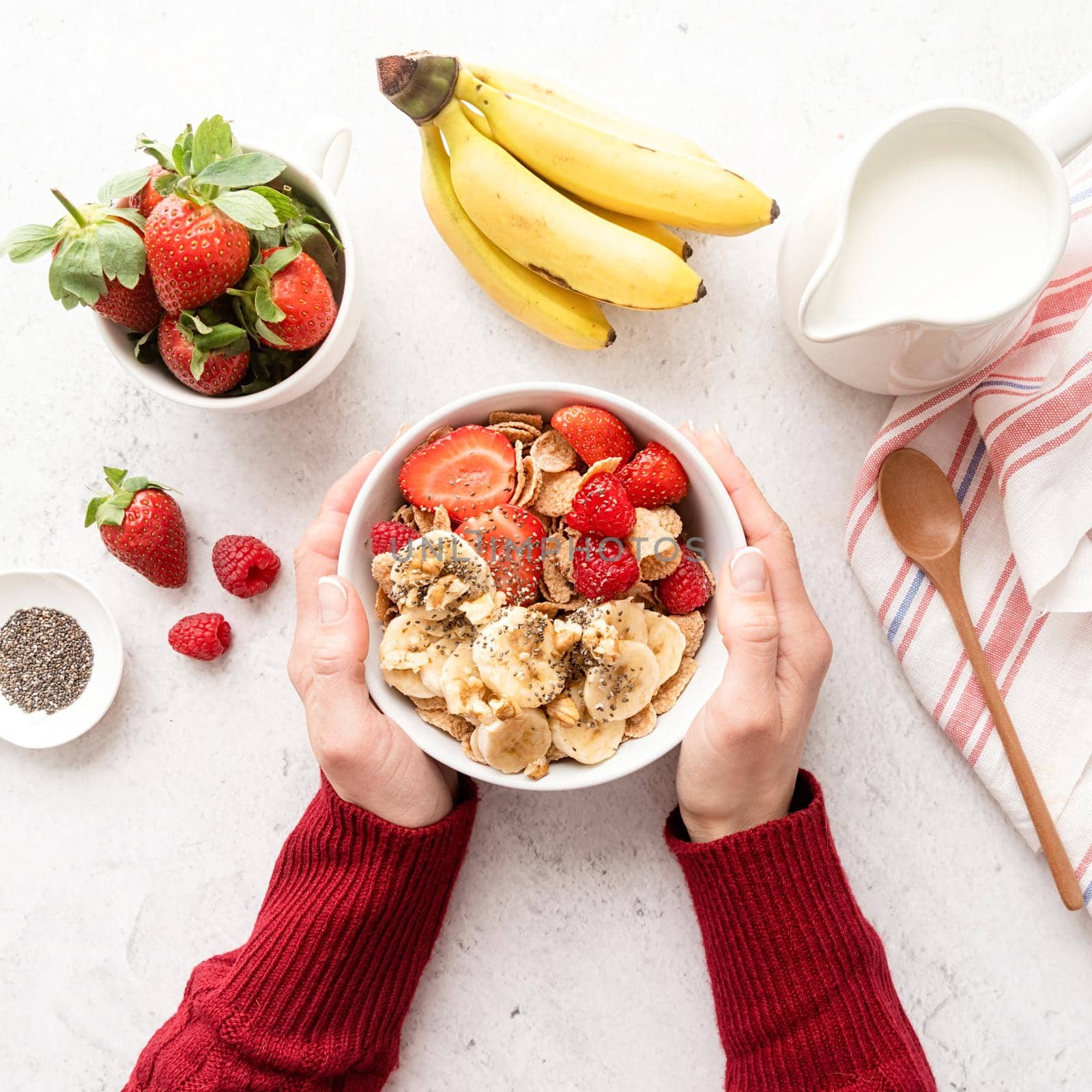 Healthy breakfast, cereal, fresh berries and milk in a bowl, top view by Desperada