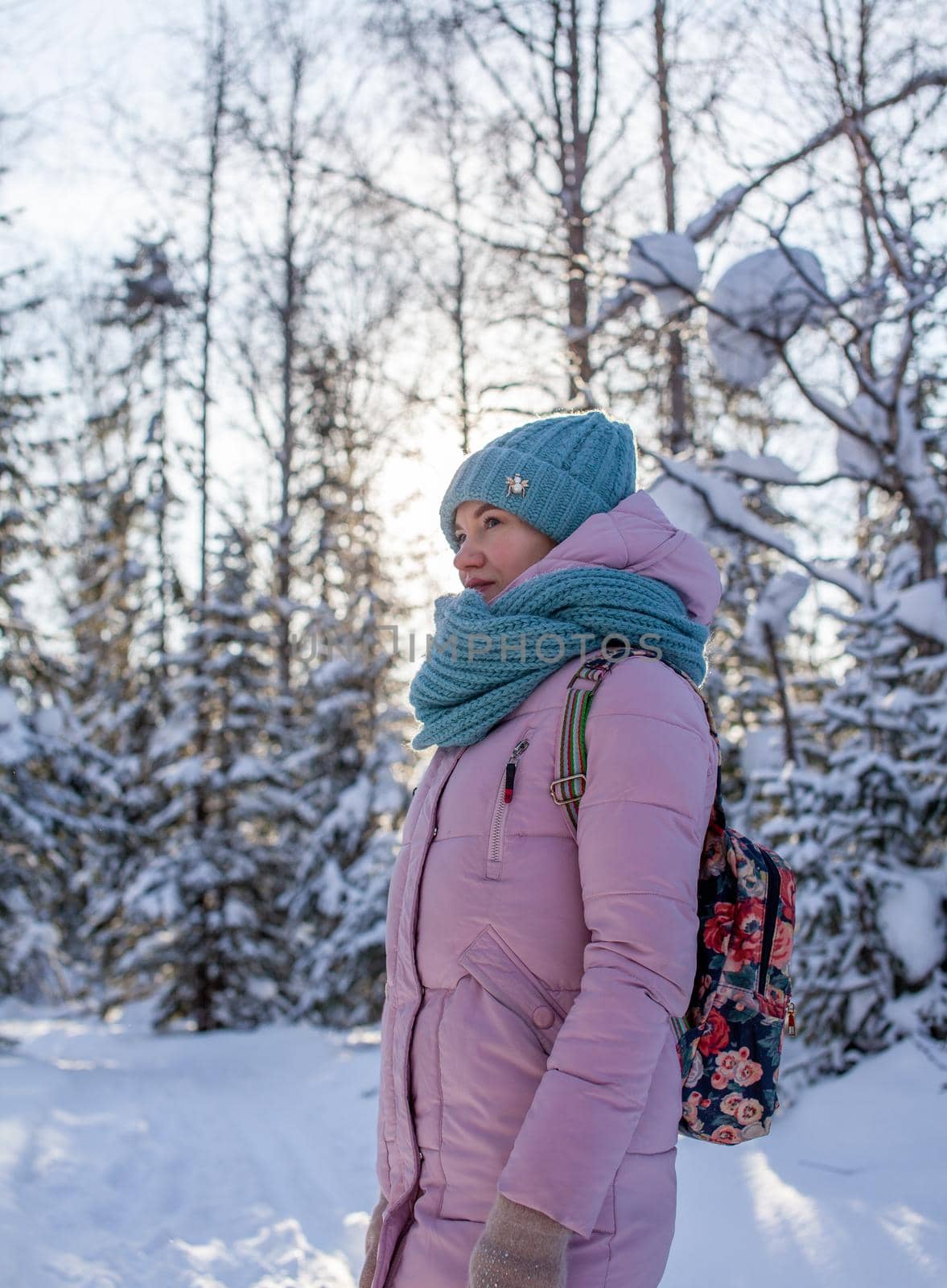 A girl in a red jacket walks through a snow-covered forest by AnatoliiFoto