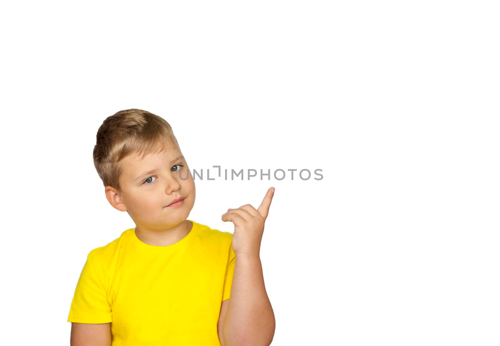 A boy in a yellow T-shirt on a white background points his fingers at something. The concept of a banner with information. Space for the text.  by Alina_Lebed