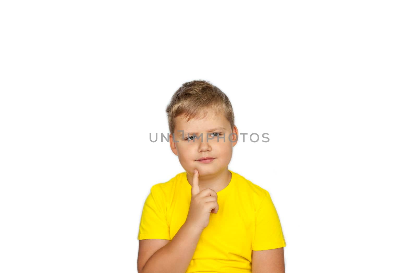 A boy in a yellow T-shirt on a white background experiences an emotion of surprise. The concept of a banner with information. Space for the text.  by Alina_Lebed