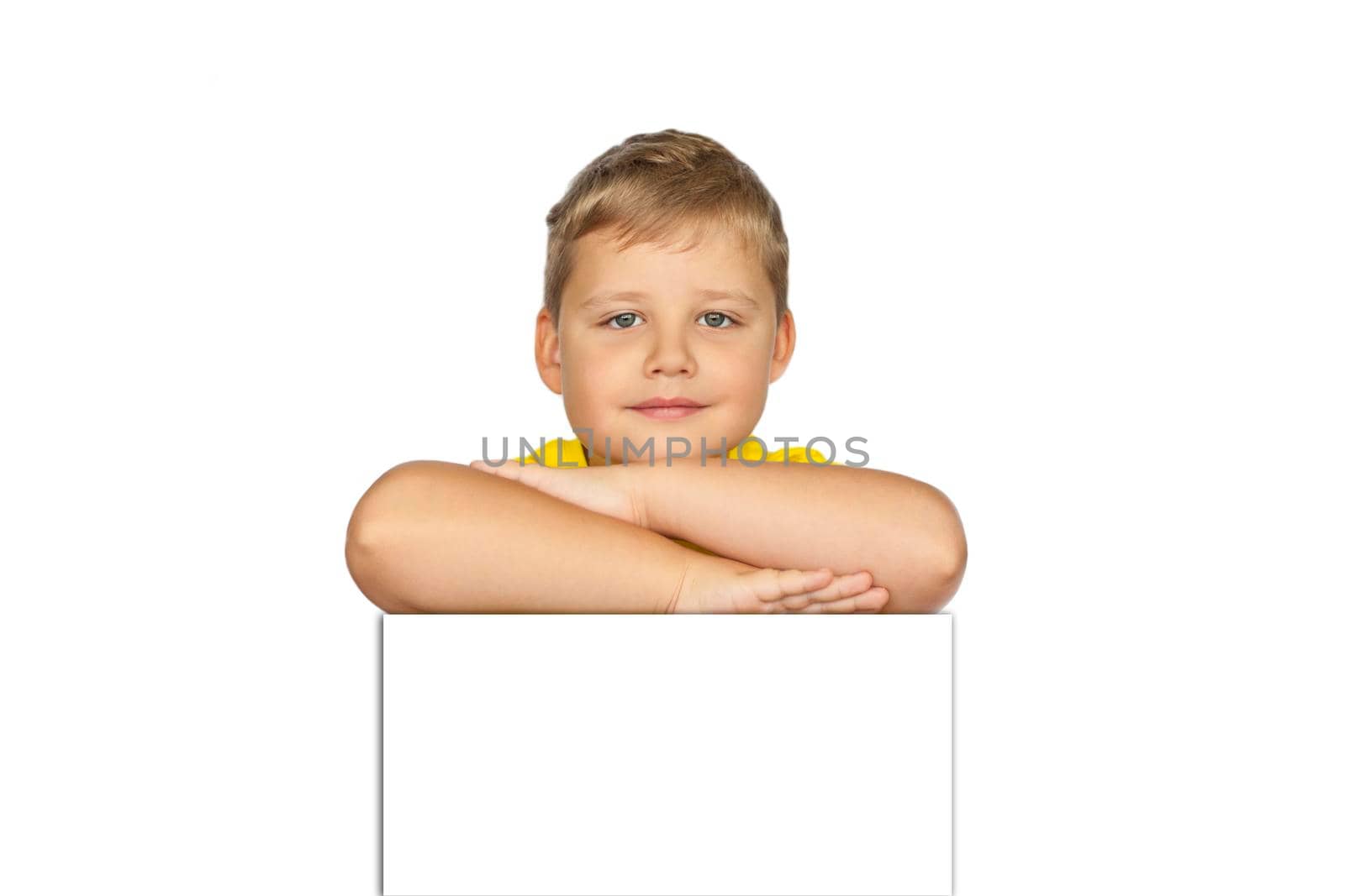 A boy in a yellow T-shirt on a white background. The concept of a banner with information. Space for the text. Concepts