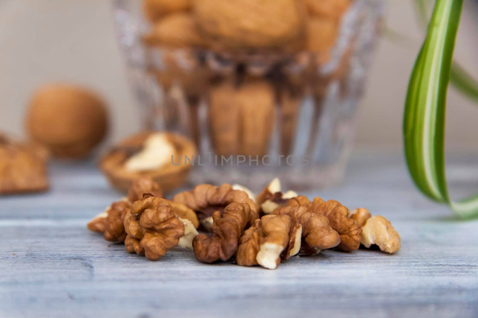 Walnuts on a painted background. Crystal bowl with nuts. Useful products. Walnuts.