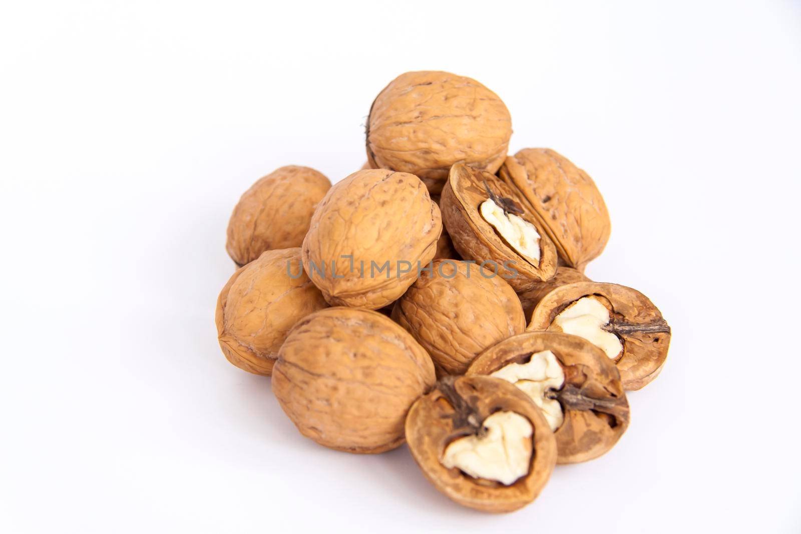 Walnuts in a shell on a white background. Healthy nuts. Walnuts.