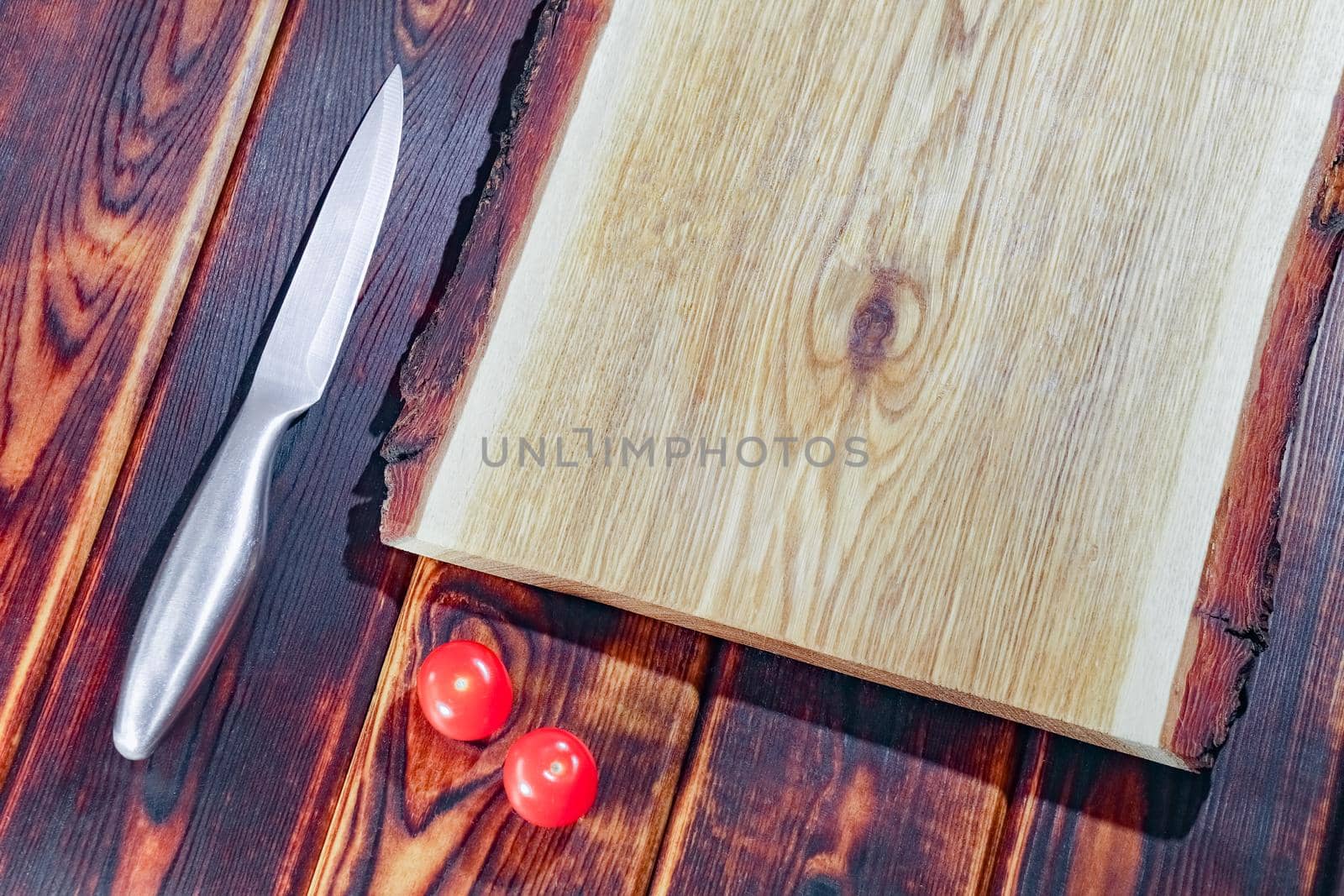 cutting Board with a knife and tomatoes top view by roman112007