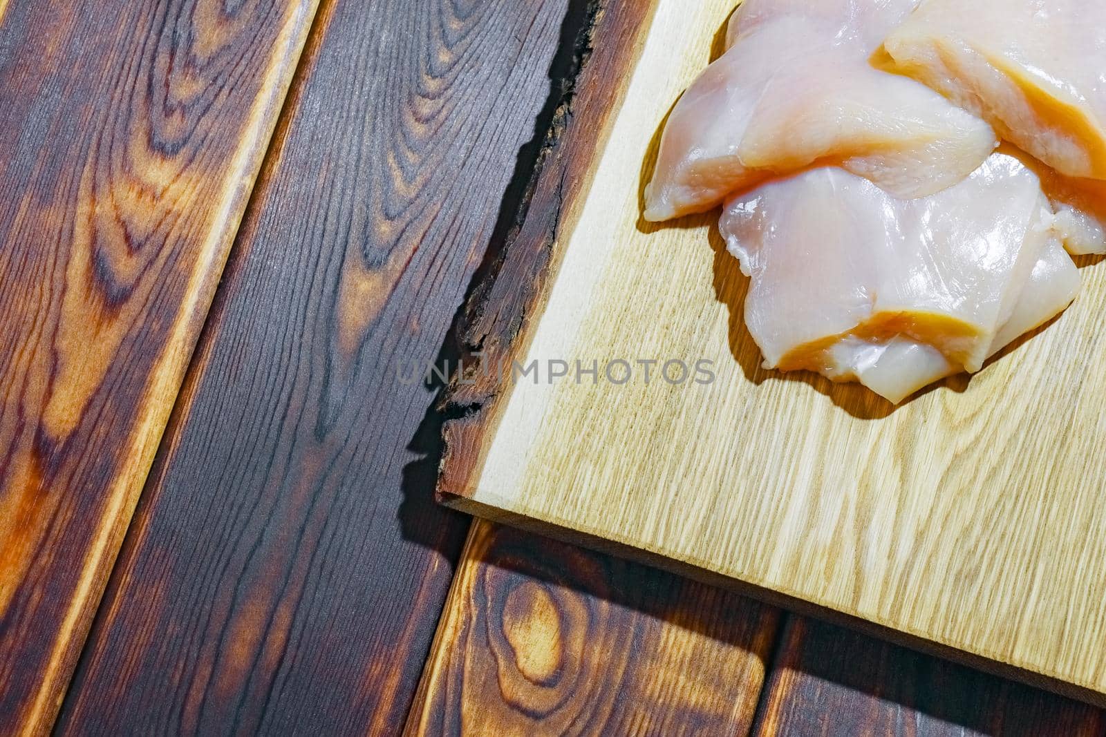 chicken fillet on a cutting Board top view by roman112007