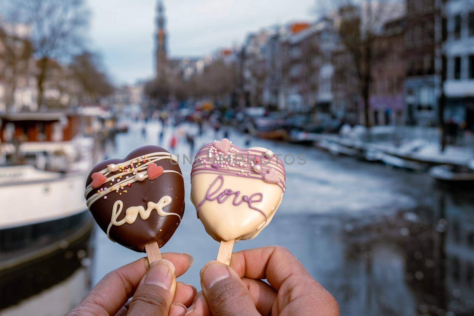 love romantic ice cream with on the background people ice skating at the frozen canals of Amsterdam, Valentine Romantic concept. Amsterdam Netherlands