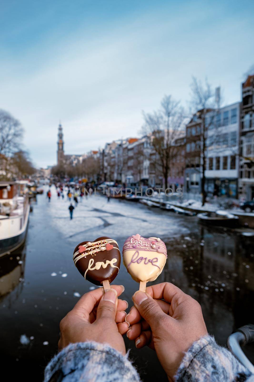 love romantic ice cream with on the background people ice skating at the frozen canals of Amsterdam, Valentine Romantic concept. Amsterdam Netherlands