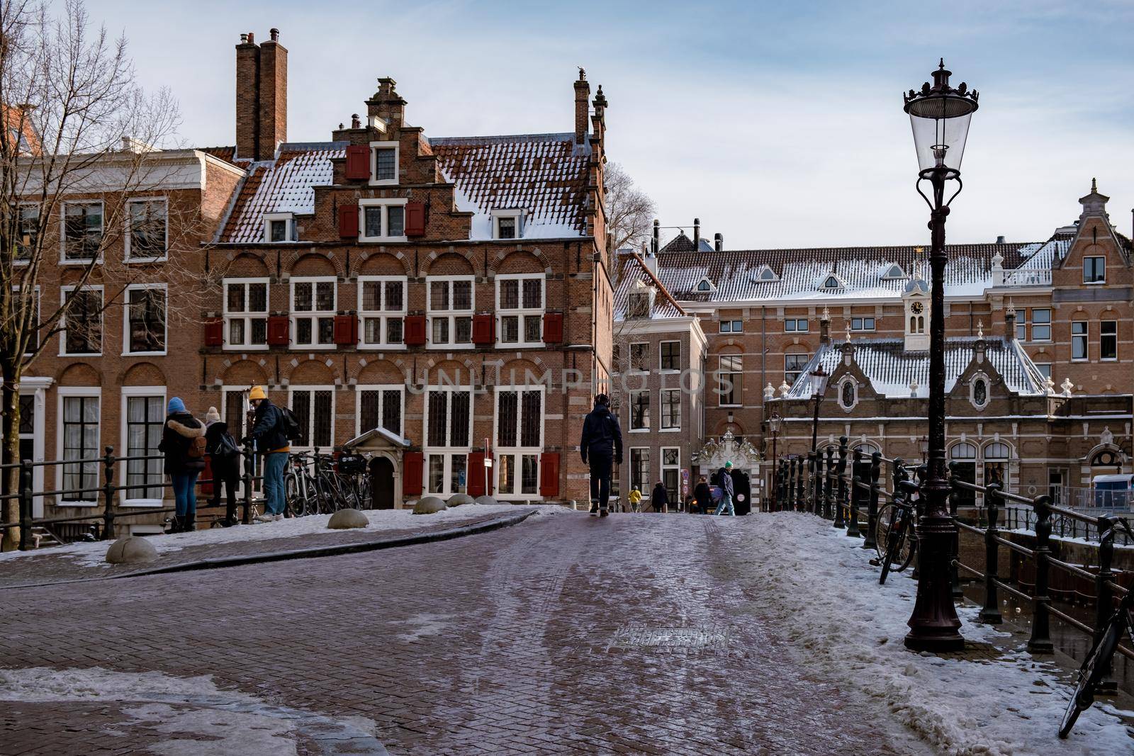 Amsterdam during winter with snowy streets. Amsterdam Netherlands February 2021
