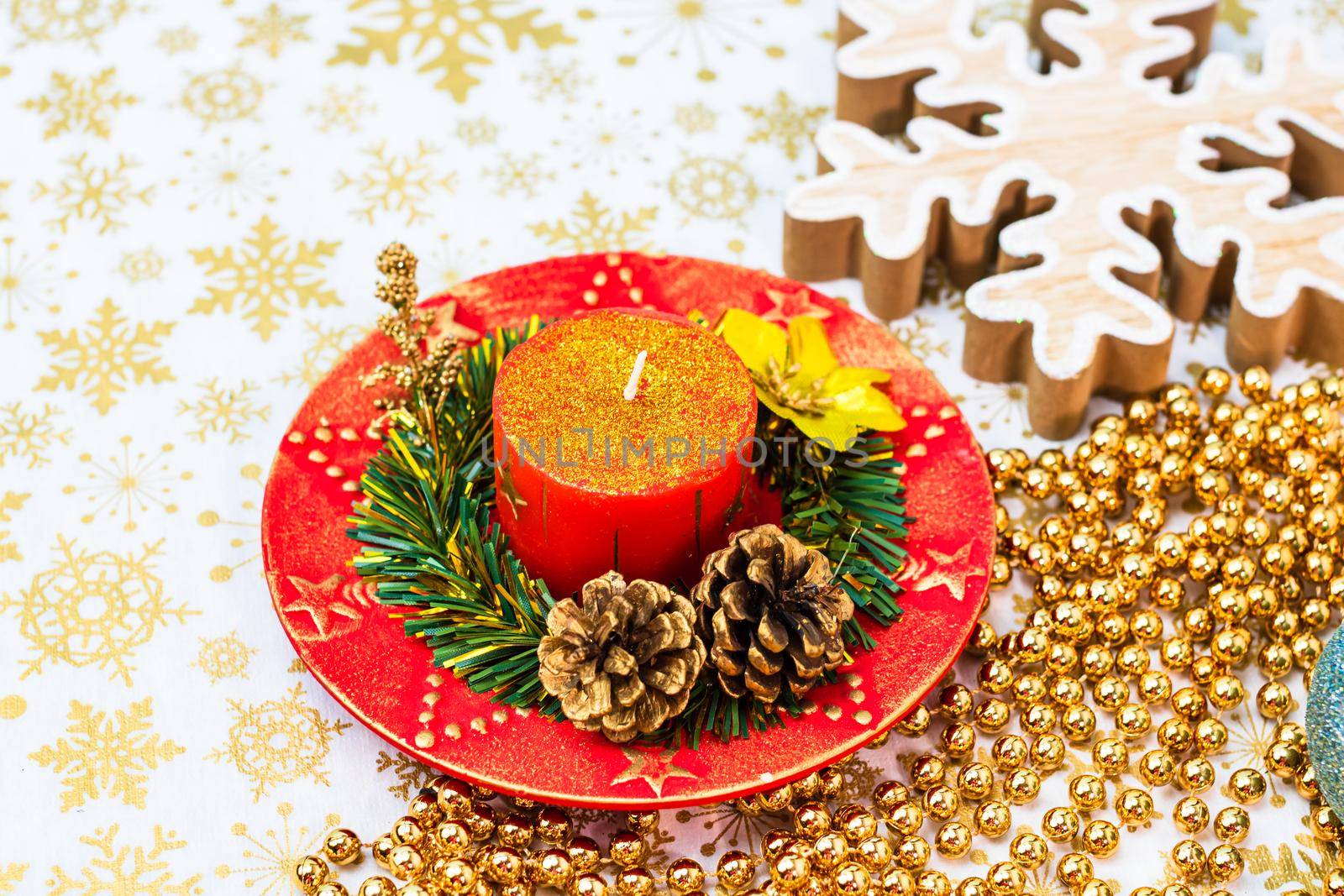 Close up of decorated christmas red candle isolated. Christmas composition with seasonal decorations and ornaments, colorful christmas background christmassy mood concept.