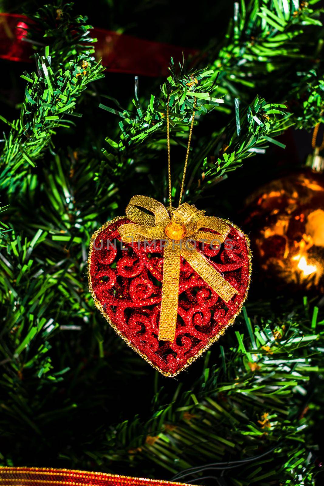 Christmas hanging decorations on fir tree. Decorated Christmas tree. Fir branch with Christmas baubles decorations.
