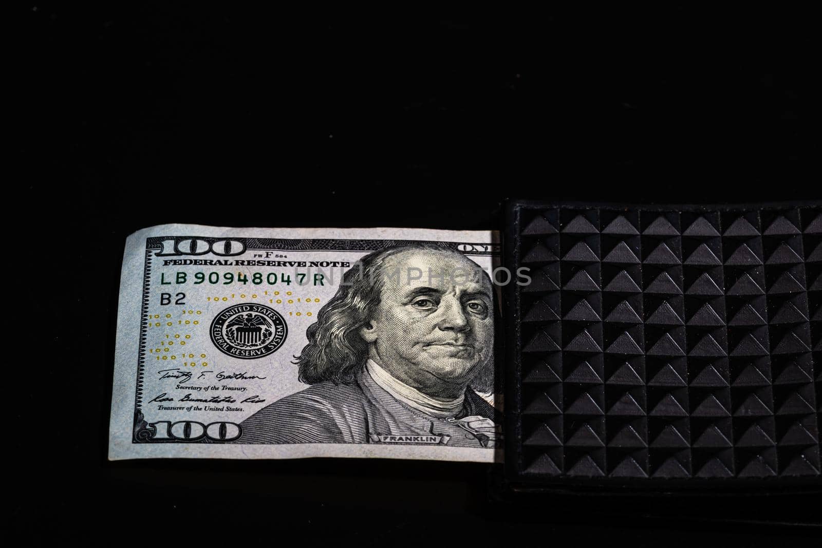 100 Dollars banknotes in a black wallet isolated by vladispas