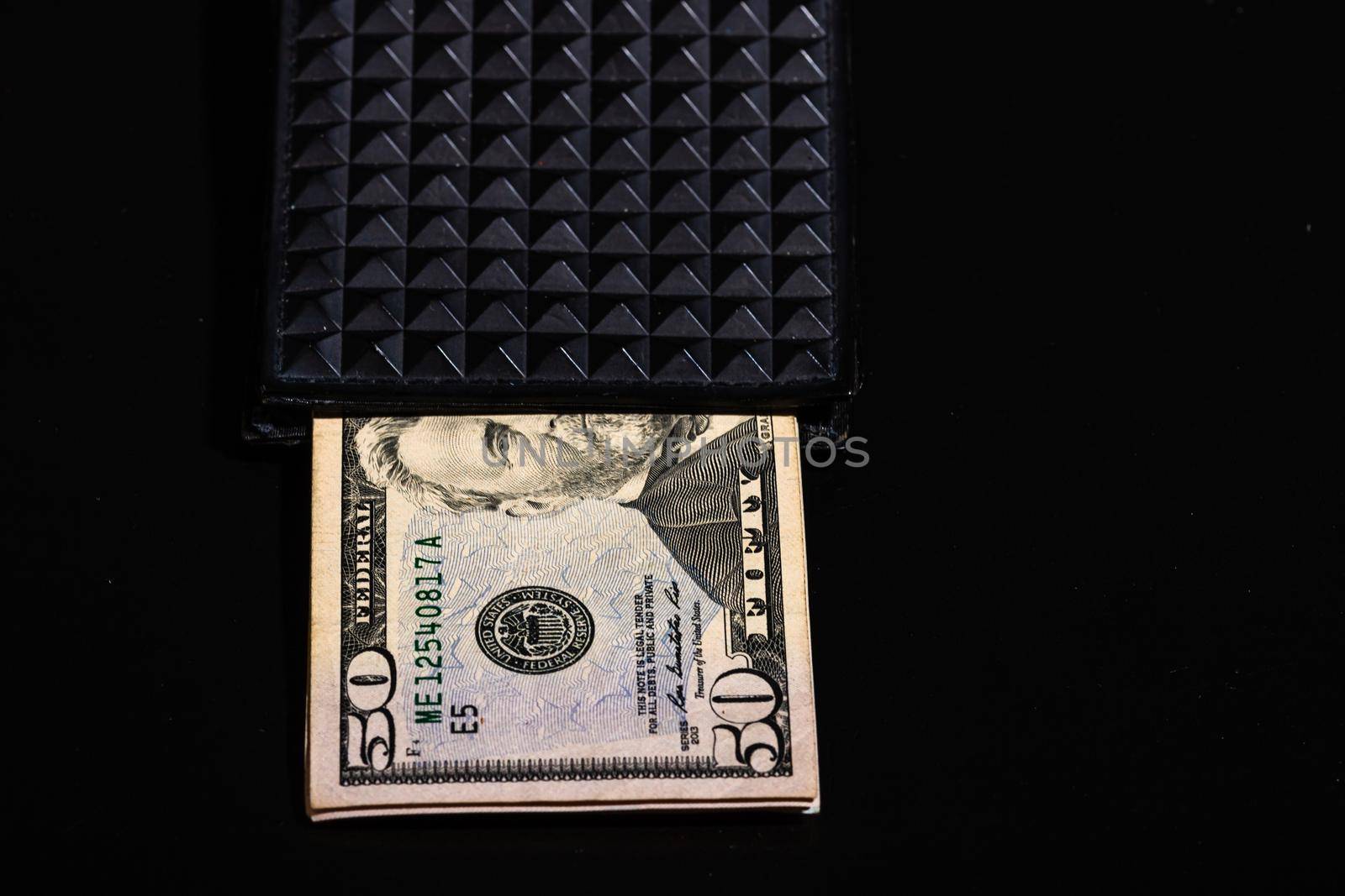 50 Dollars banknotes in a black wallet isolated. by vladispas