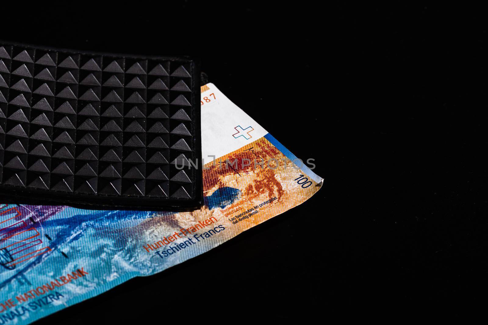  100 swiss franc banknote in a black wallet isolated. by vladispas