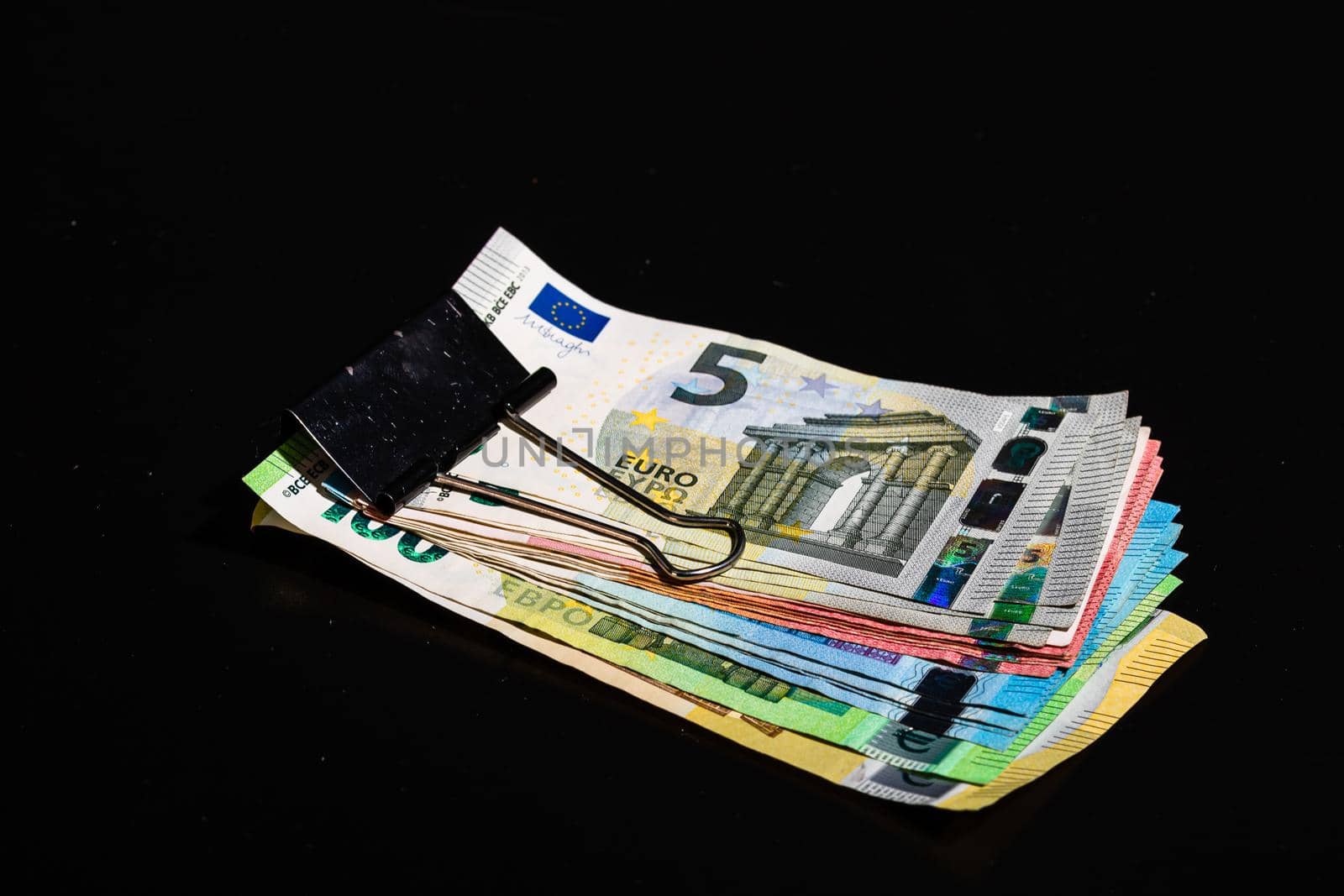 Close up on stack of EURO money. Euro banknotes isolated. by vladispas