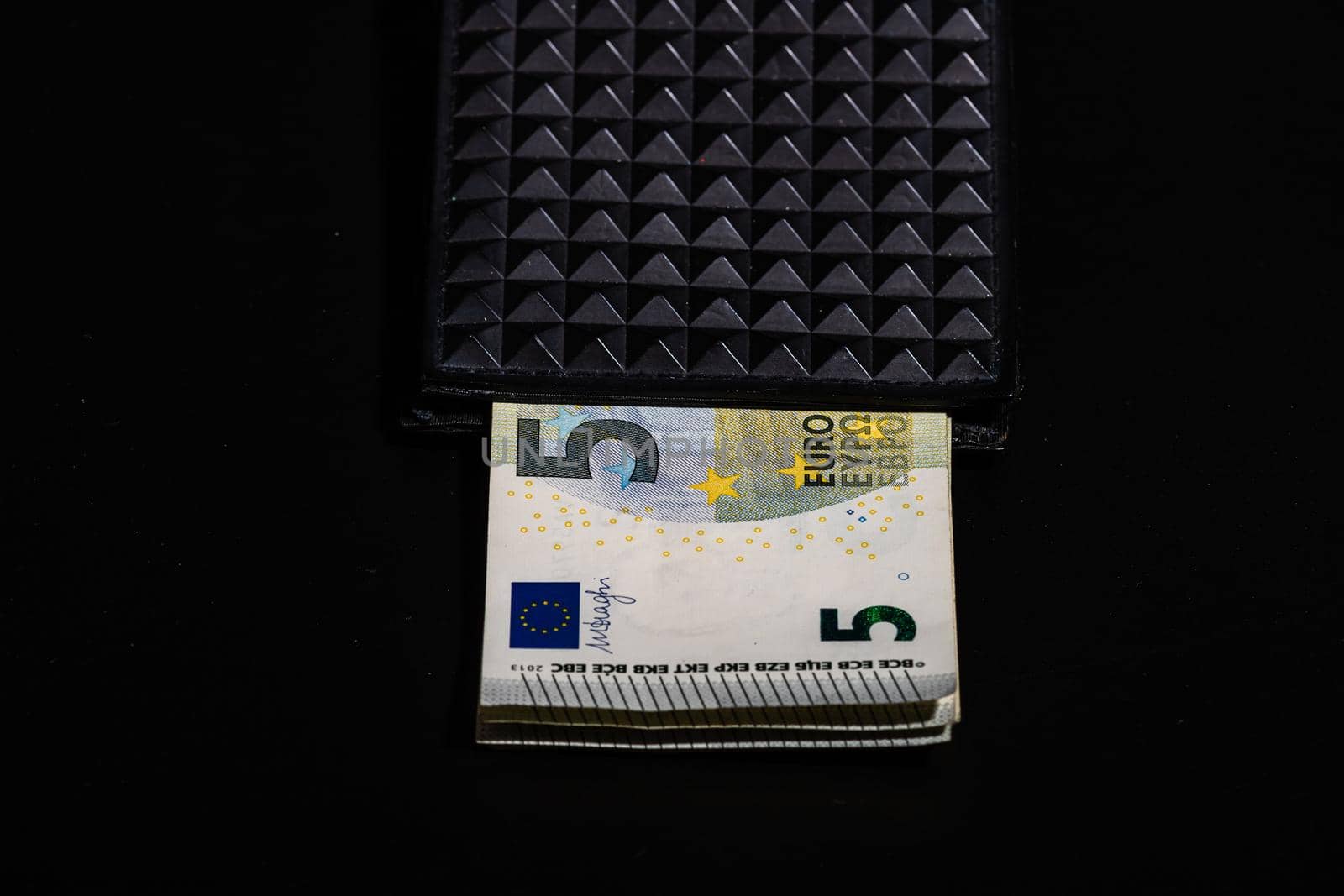 5 Euro money banknotes in black wallet isolated by vladispas