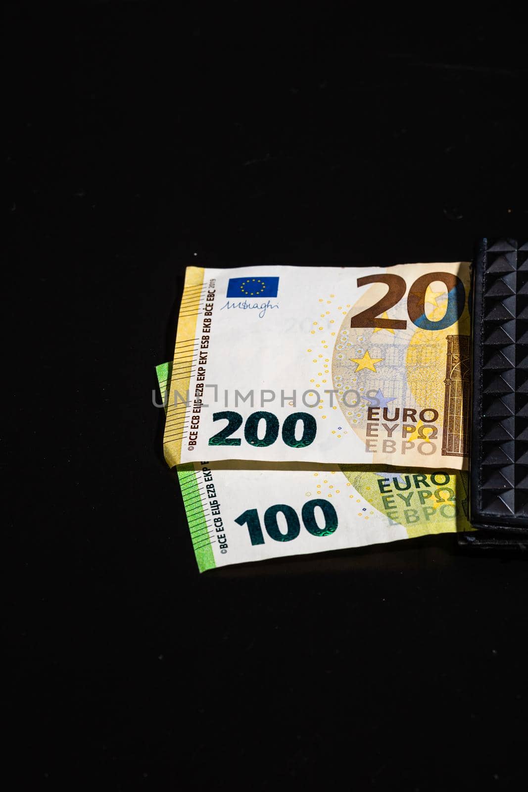 100 euro and 200 euro banknotes in black wallet isolated by vladispas